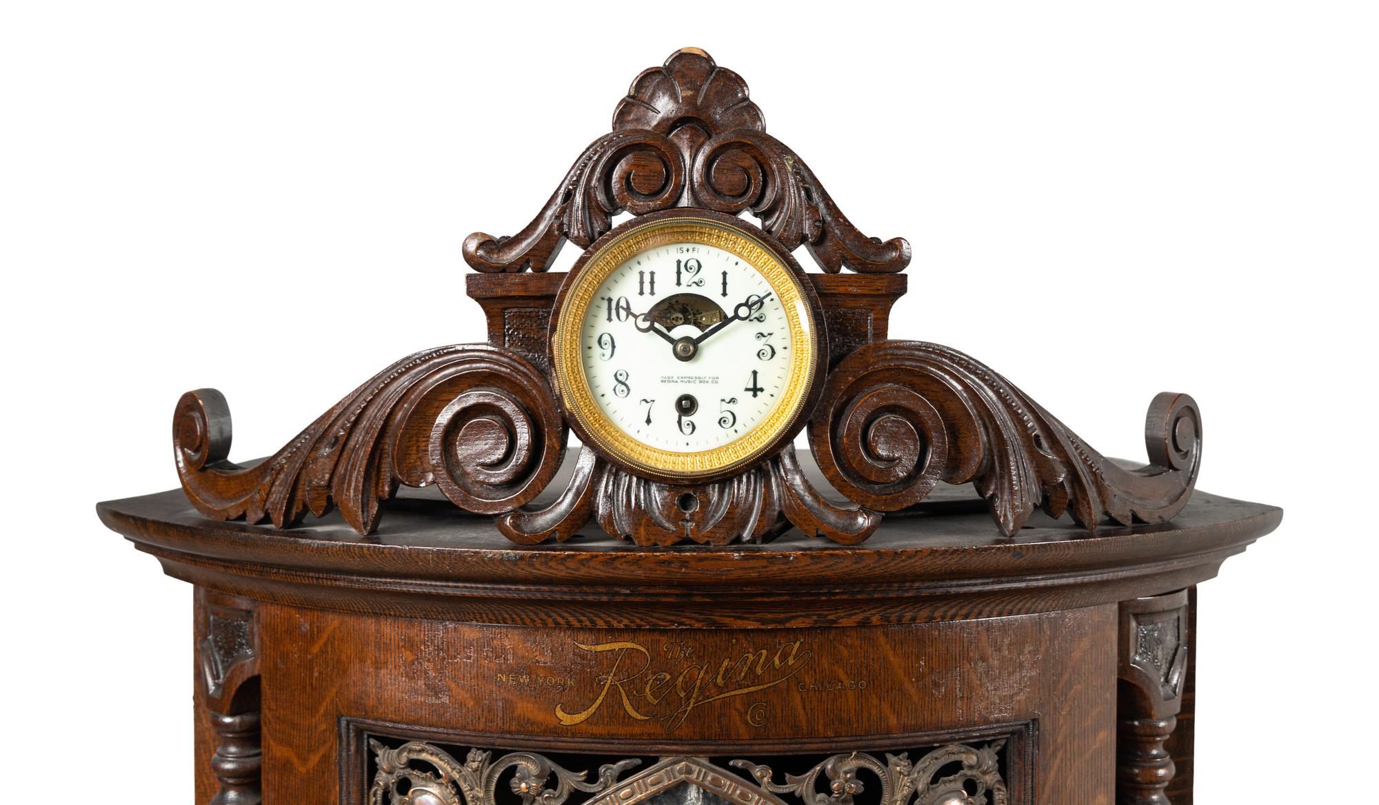 A Regina Corona 15 1/2 Inch Disk Change Music Box with Clock