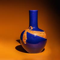 A Large Chinese Gilt and Iron Red Highlighted Blue Glazed Porcelain 'Ribbon-Tied' Vase, Tianqiuping, Late Qing Dynasty/Early Republic Period 晚清/民國 藍地描金包袱式天球瓶