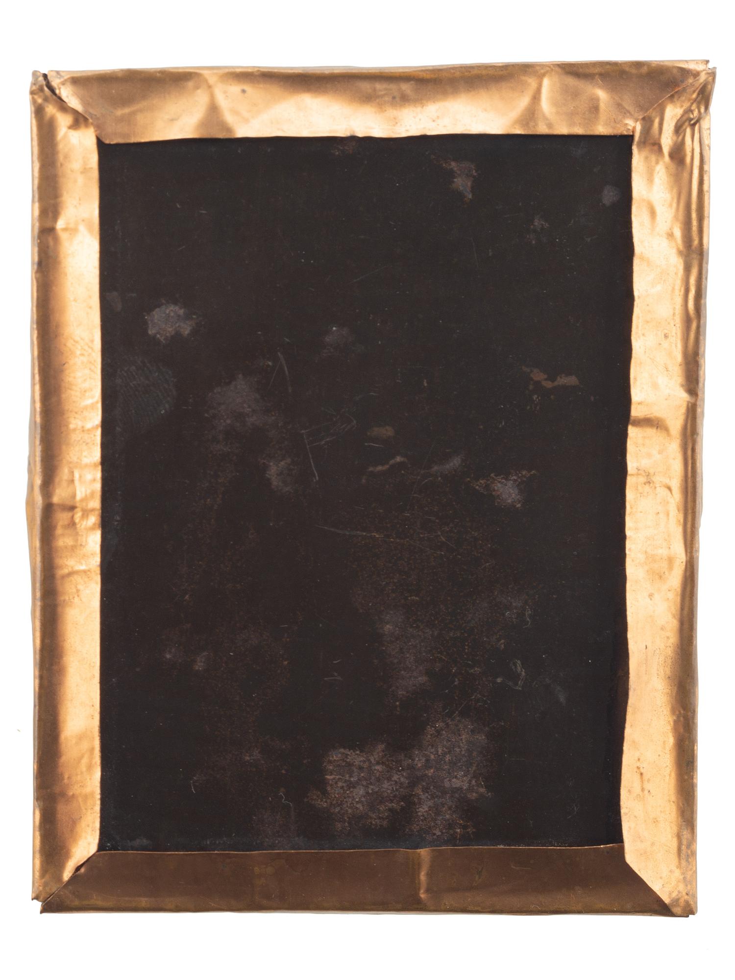 [CIVIL WAR]. Quarter plate tintype of a soldier walking down the street of a likely Carolina town, with sign for oyster saloon partly visible.