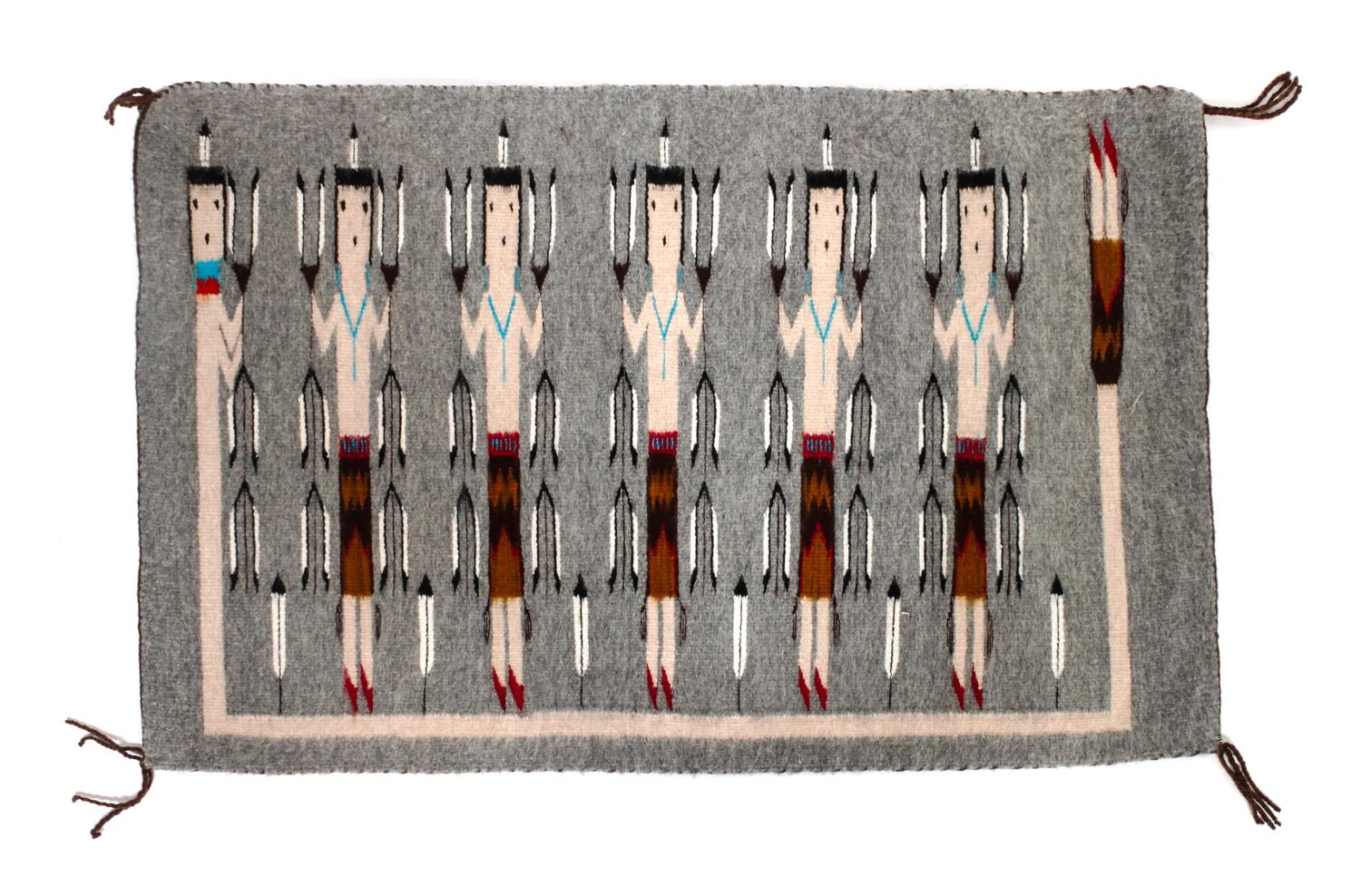 A Navajo Yei Rug First: 33 x 21 inches.