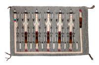 A Navajo Yei Rug First: 33 x 21 inches.