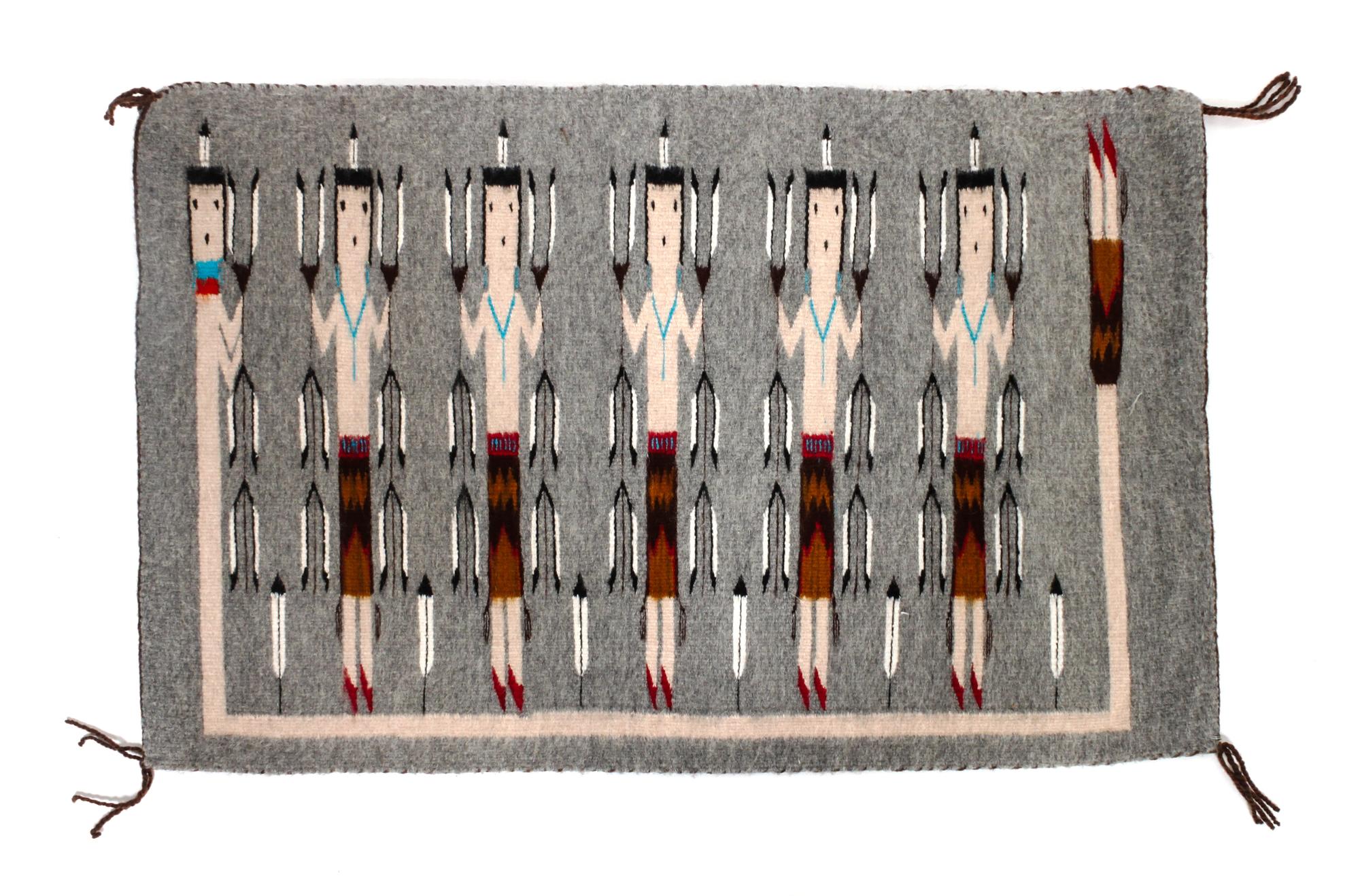 A Navajo Yei Rug First: 33 x 21 inches.