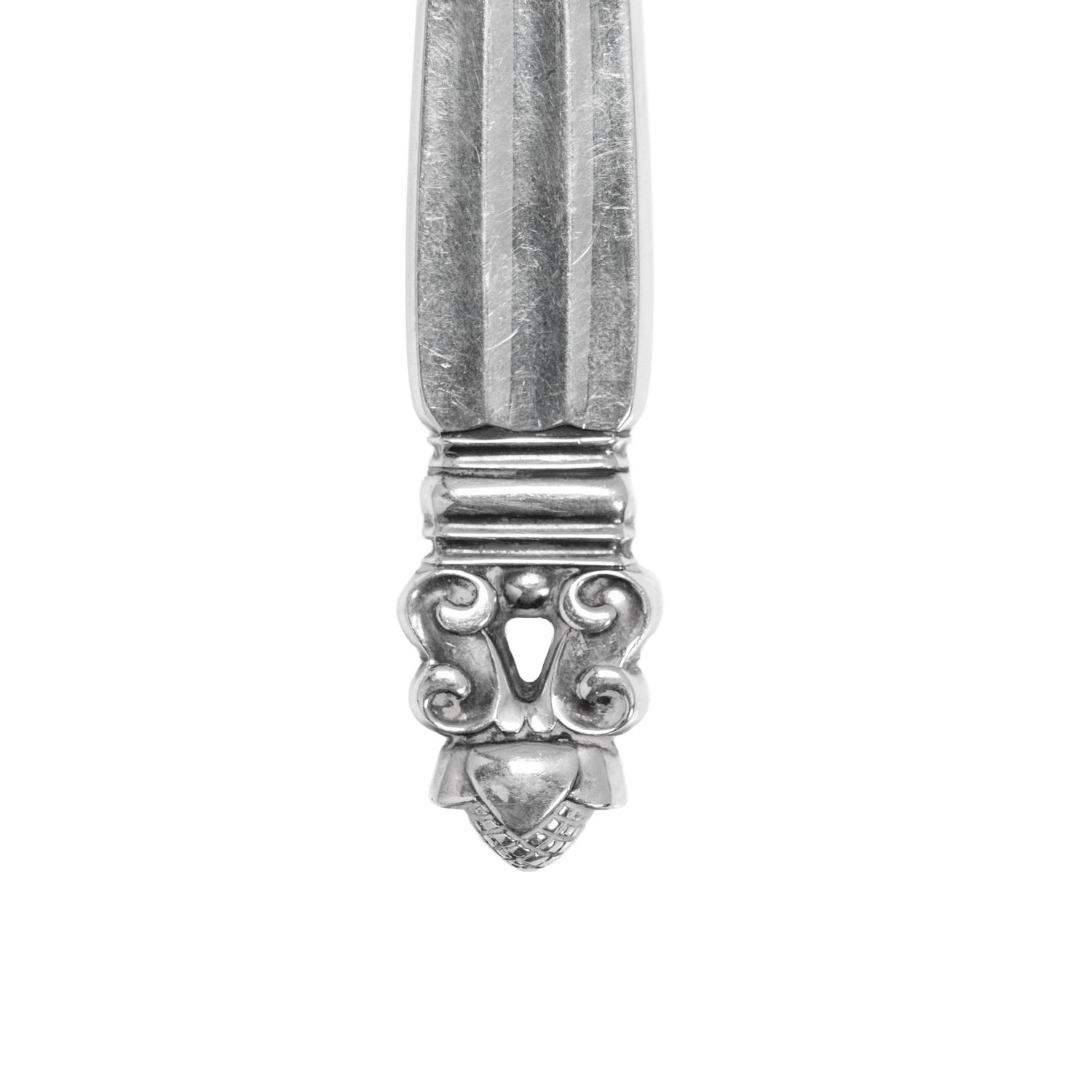 A Pair of Georg Jensen Acorn Silver Cheese Knives and a Pair of Sugar Tongs