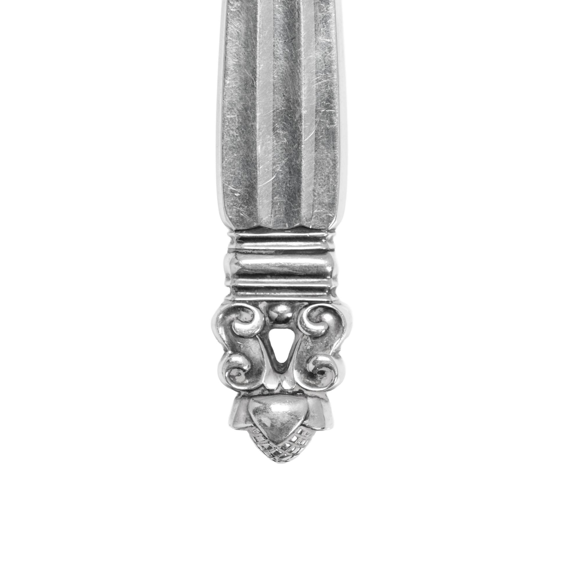 A Pair of Georg Jensen Acorn Silver Cheese Knives and a Pair of Sugar Tongs