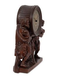 A Continental Carved Oak Figural Clock
