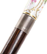 A Meissen Style Porcelain Handled Walking Stick, Length of handle 2 3/4 x length overall 31 1/2 inches.