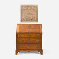 A Federal child's cherry slant-front desk together with a needlework sampler late 18th / early 19th century