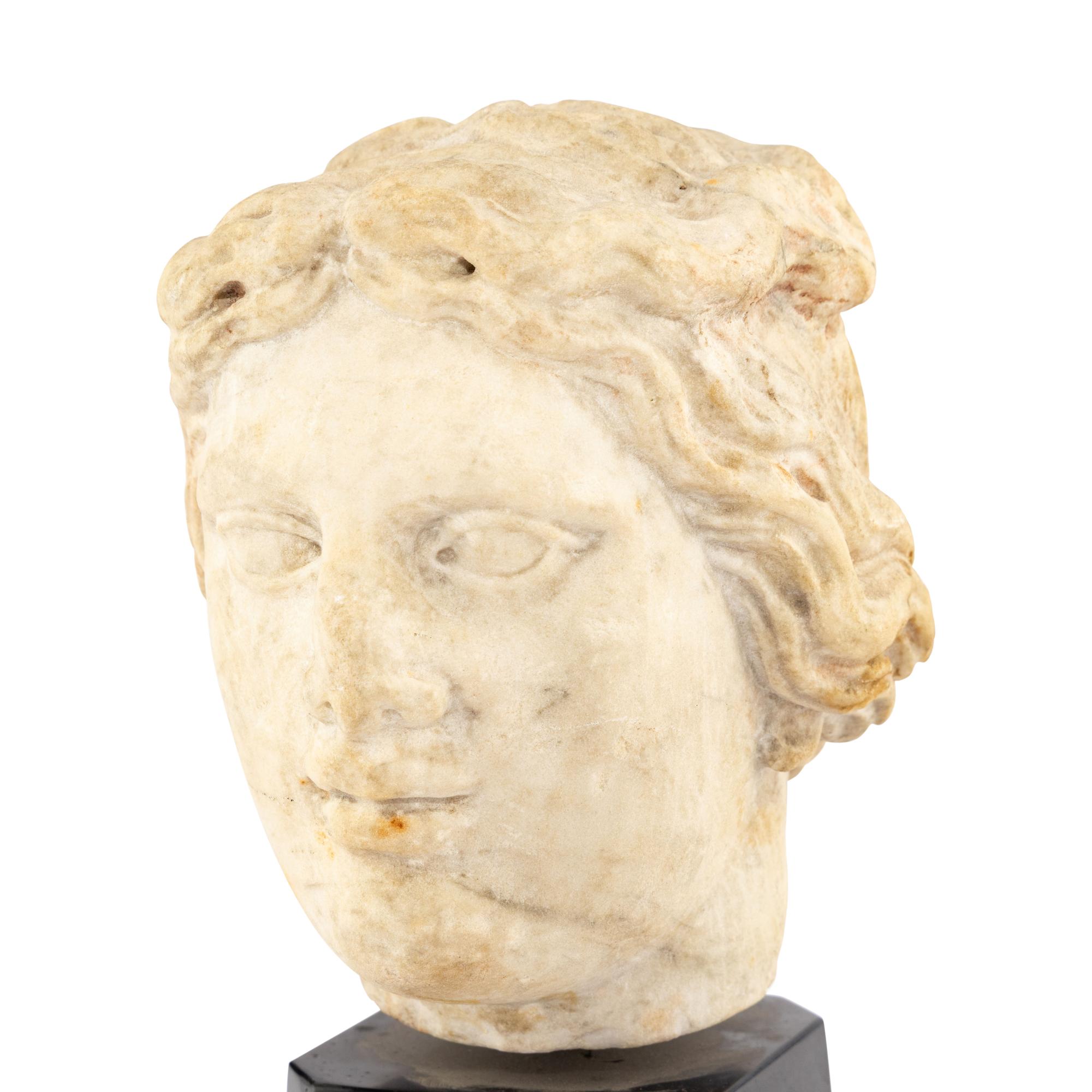 A Continental Carved Marble Head of a Woman