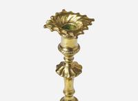 A group of eight Chippendale brass candlesticks, England, late 18th century