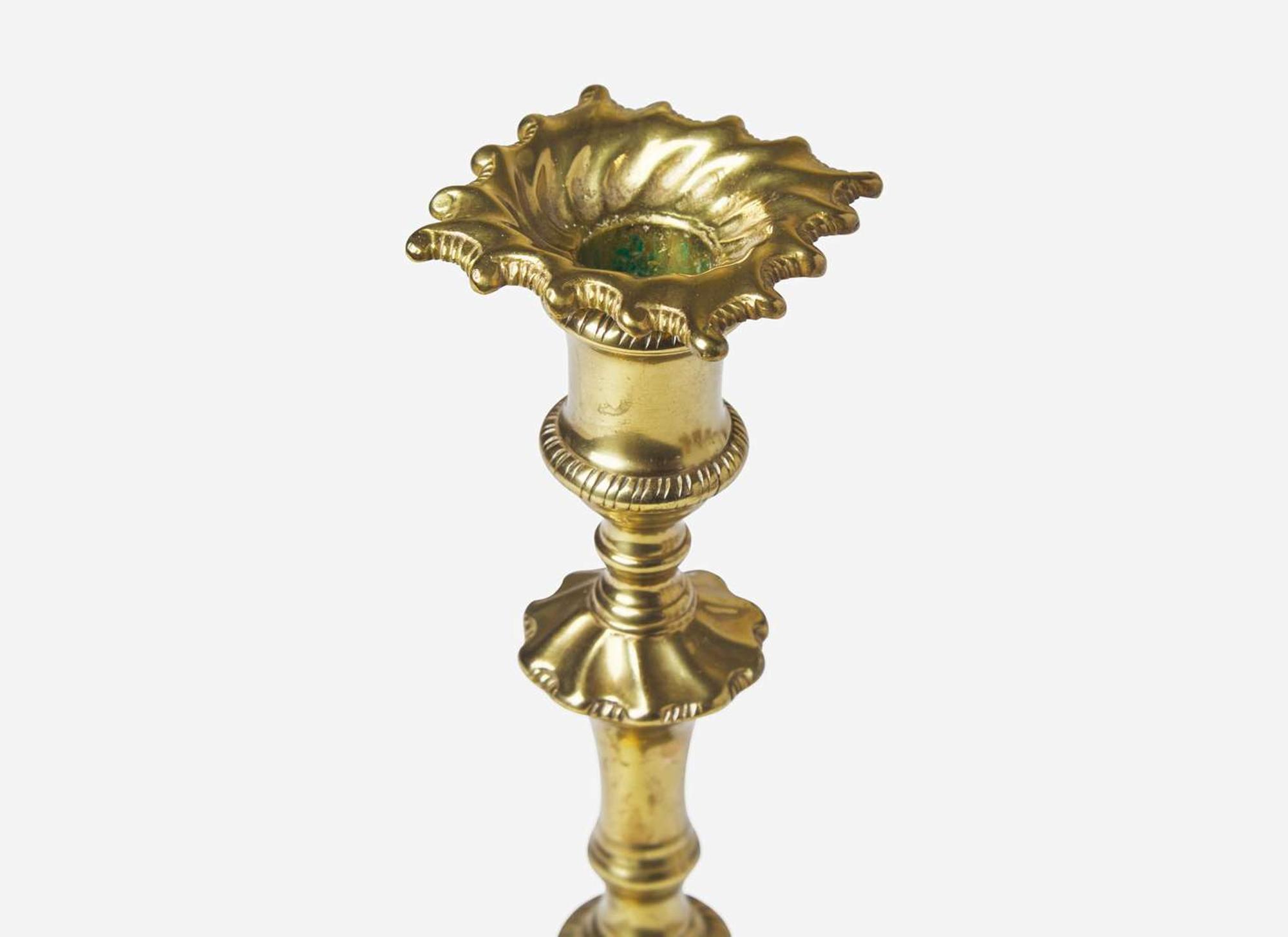 A group of eight Chippendale brass candlesticks, England, late 18th century