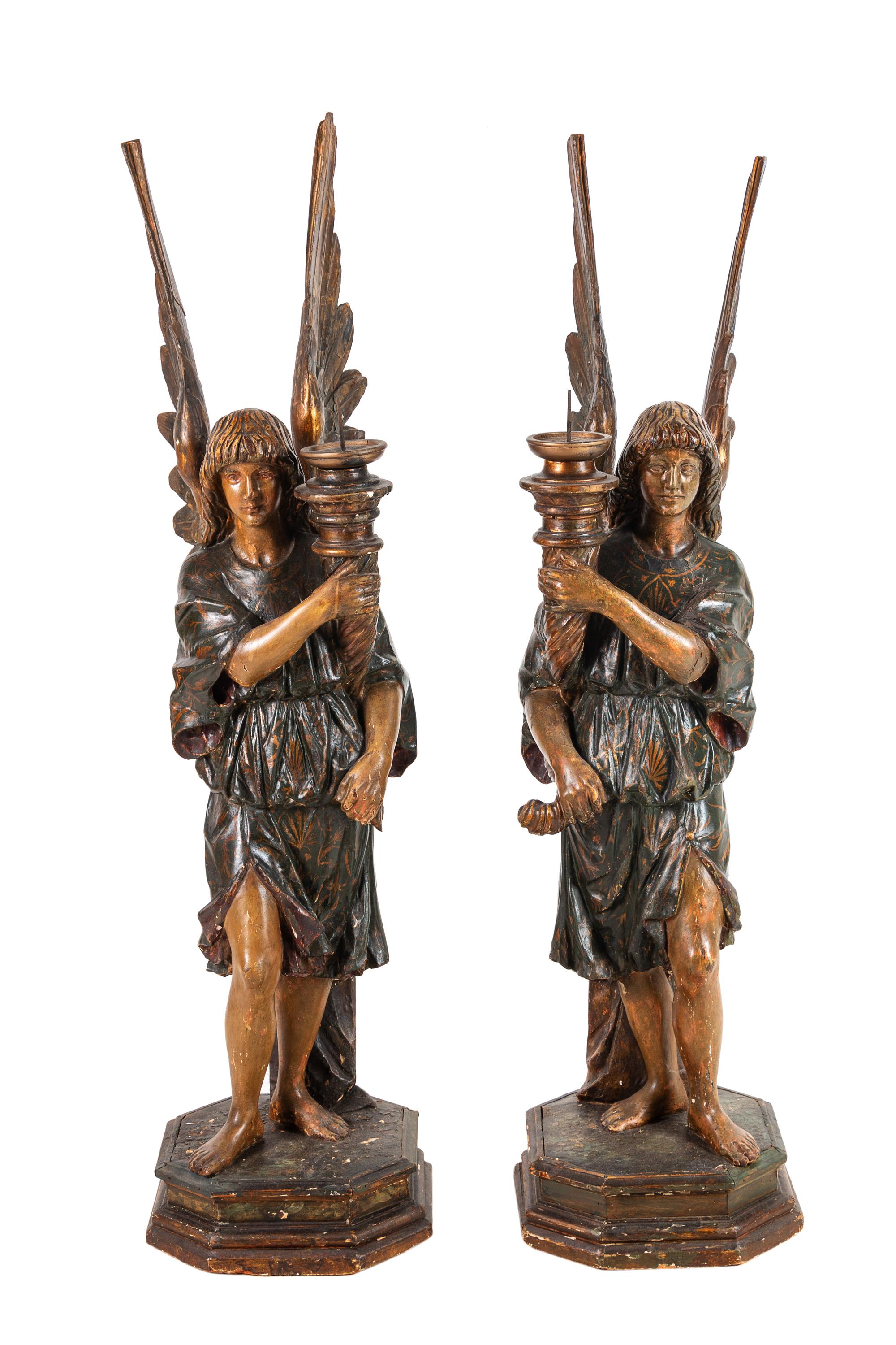 A Pair of Continental Carved and Painted Figural Prickets with Associated Pedestals
