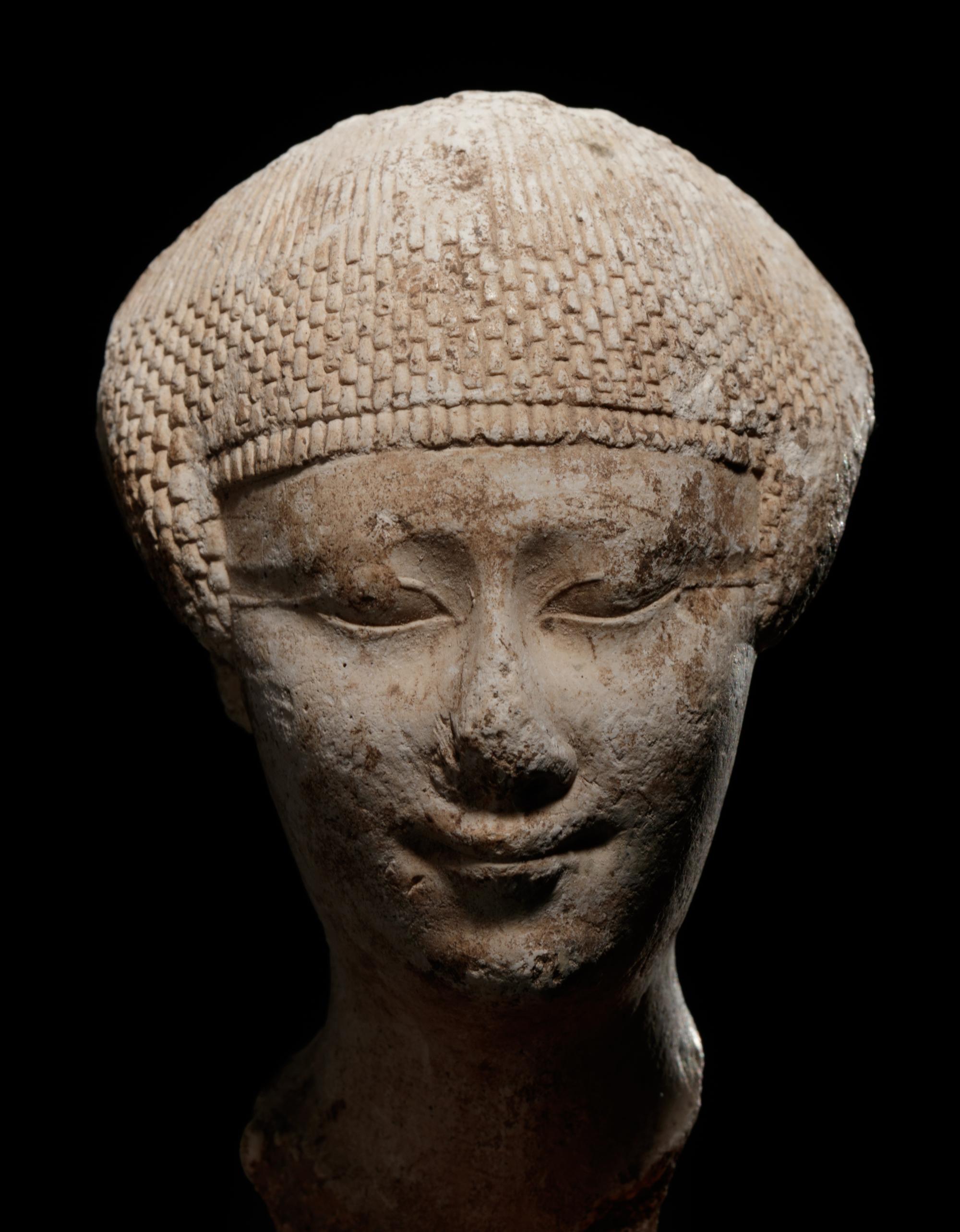 An Egyptian Limestone Head of a Noblewoman