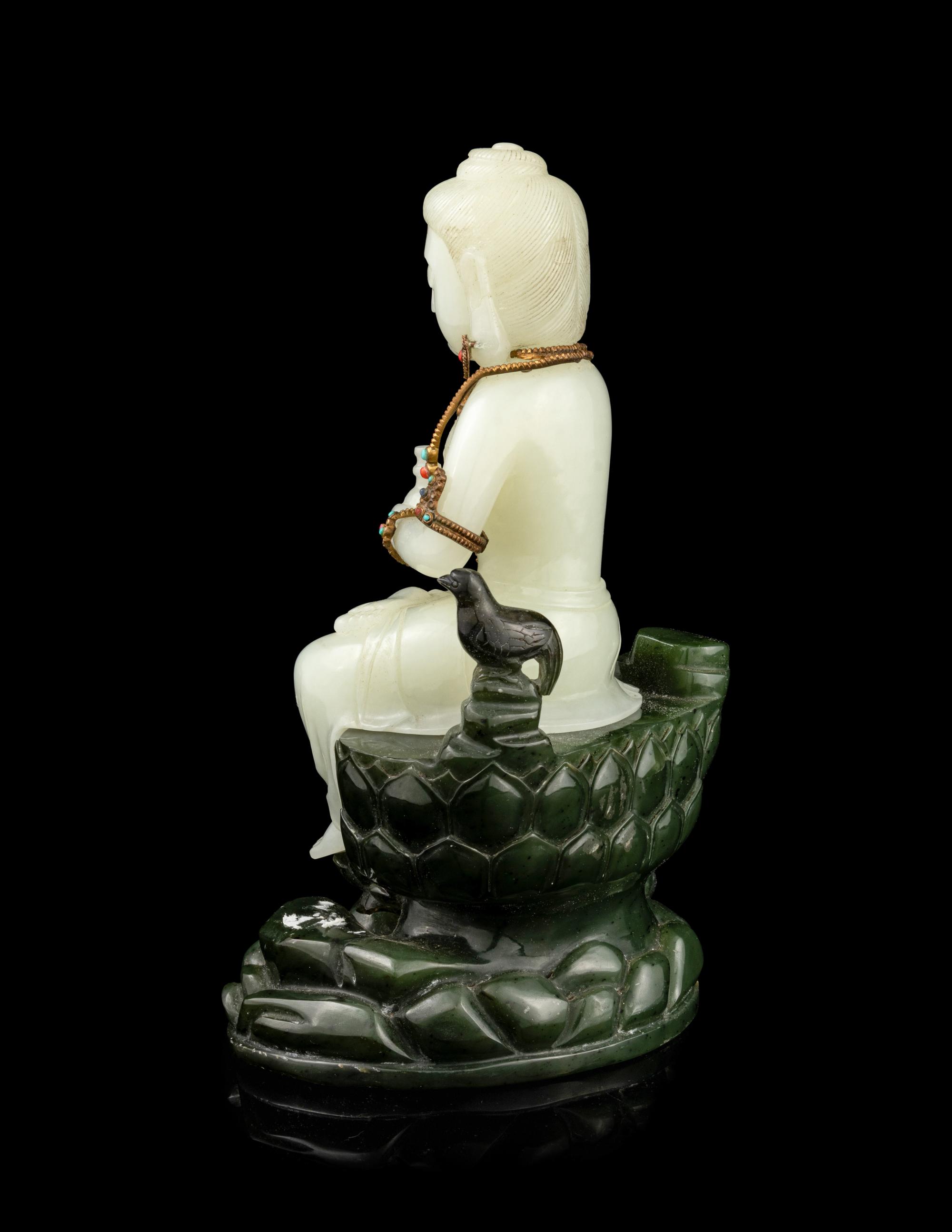 A Pale Celadon and Spinach Jade Figure of Guanyin