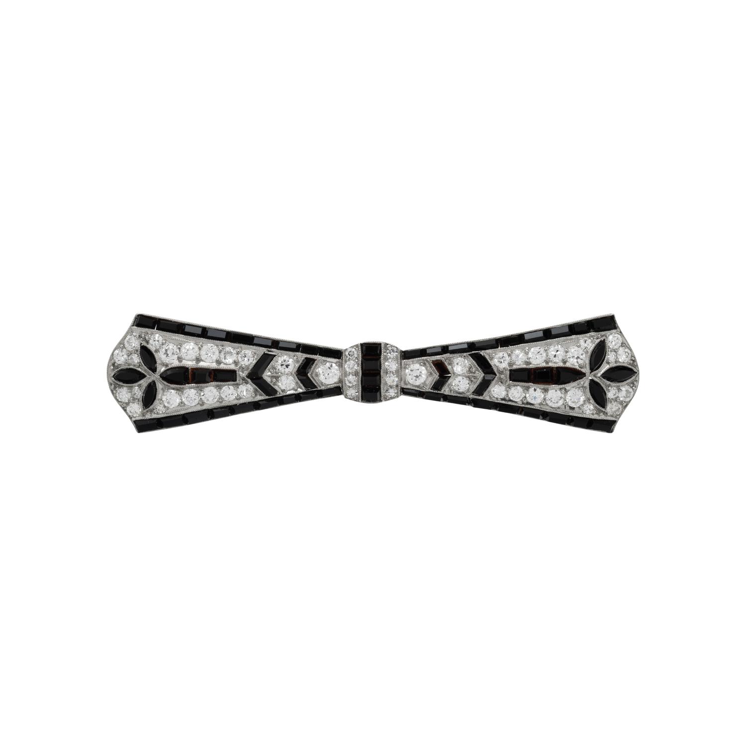 TIFFANY & CO., ART DECO, PLATINUM, DIAMOND, AND ONYX BOW BROOCH
