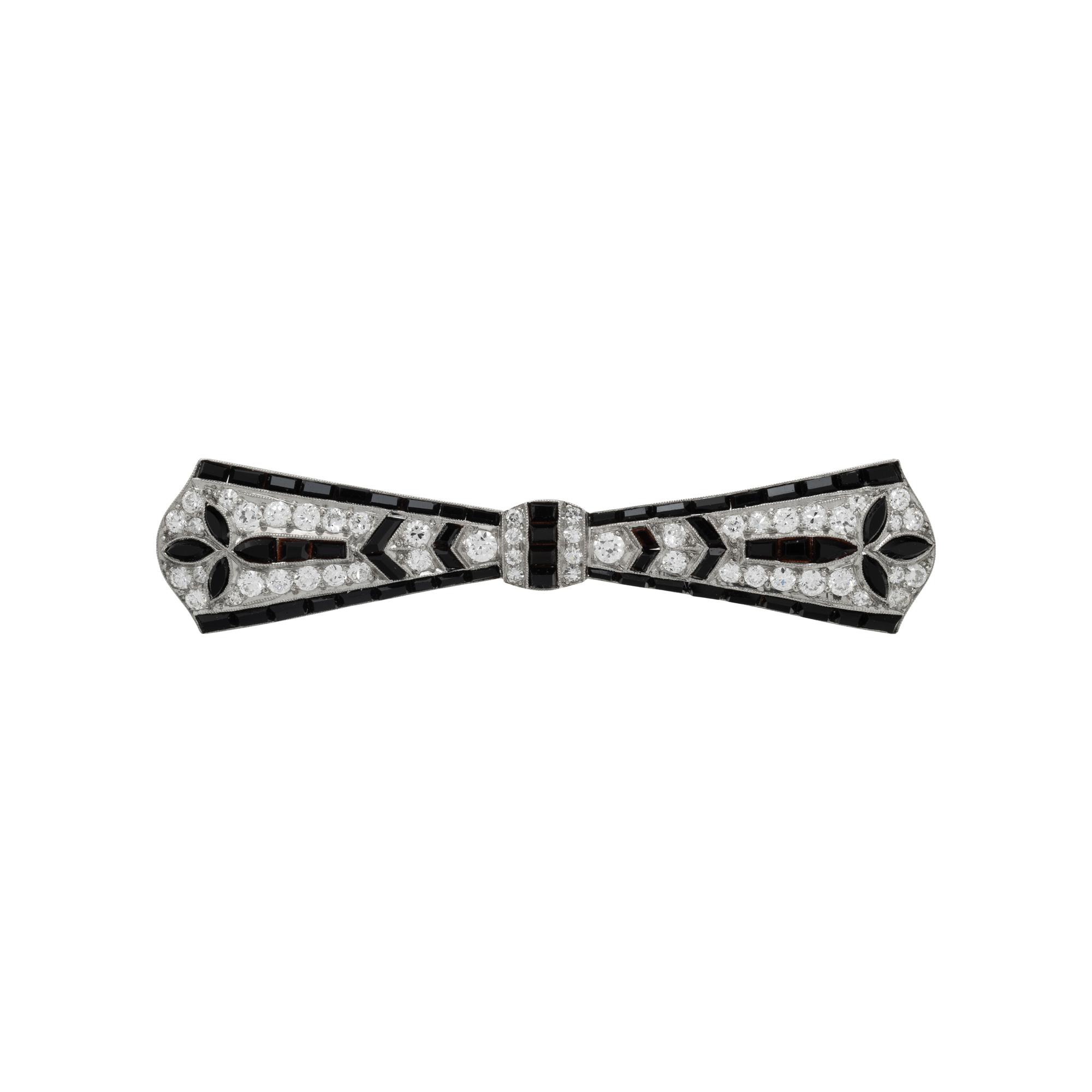 TIFFANY & CO., ART DECO, PLATINUM, DIAMOND, AND ONYX BOW BROOCH