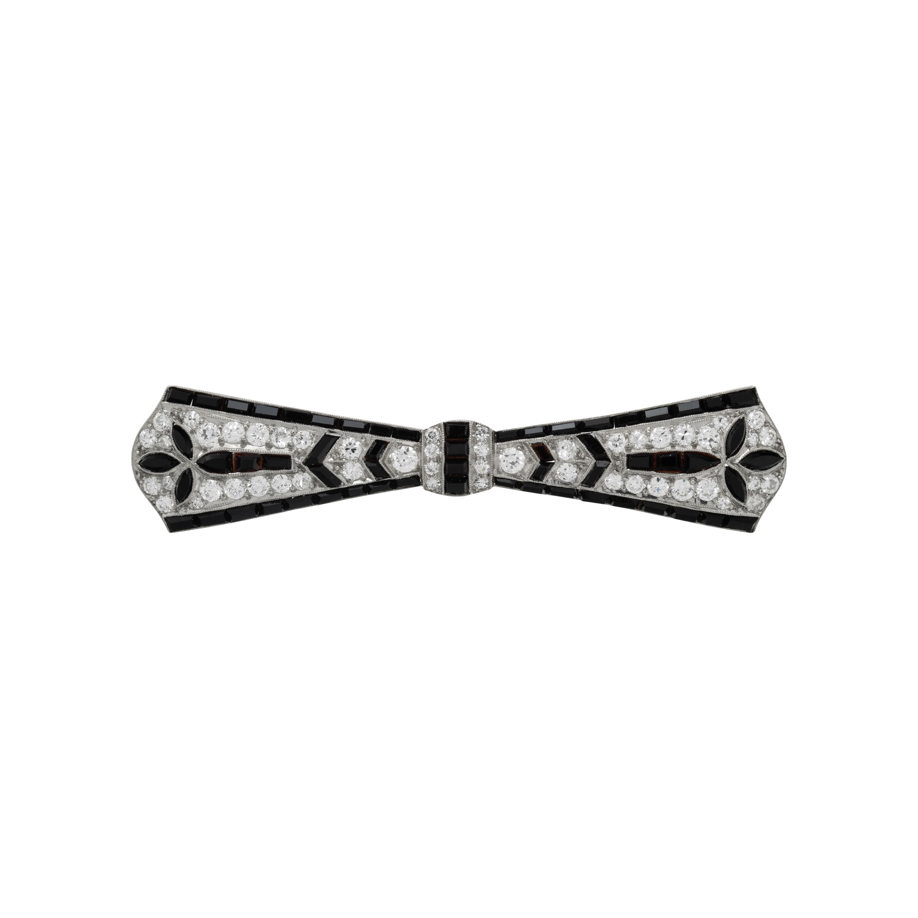 TIFFANY & CO., ART DECO, PLATINUM, DIAMOND, AND ONYX BOW BROOCH