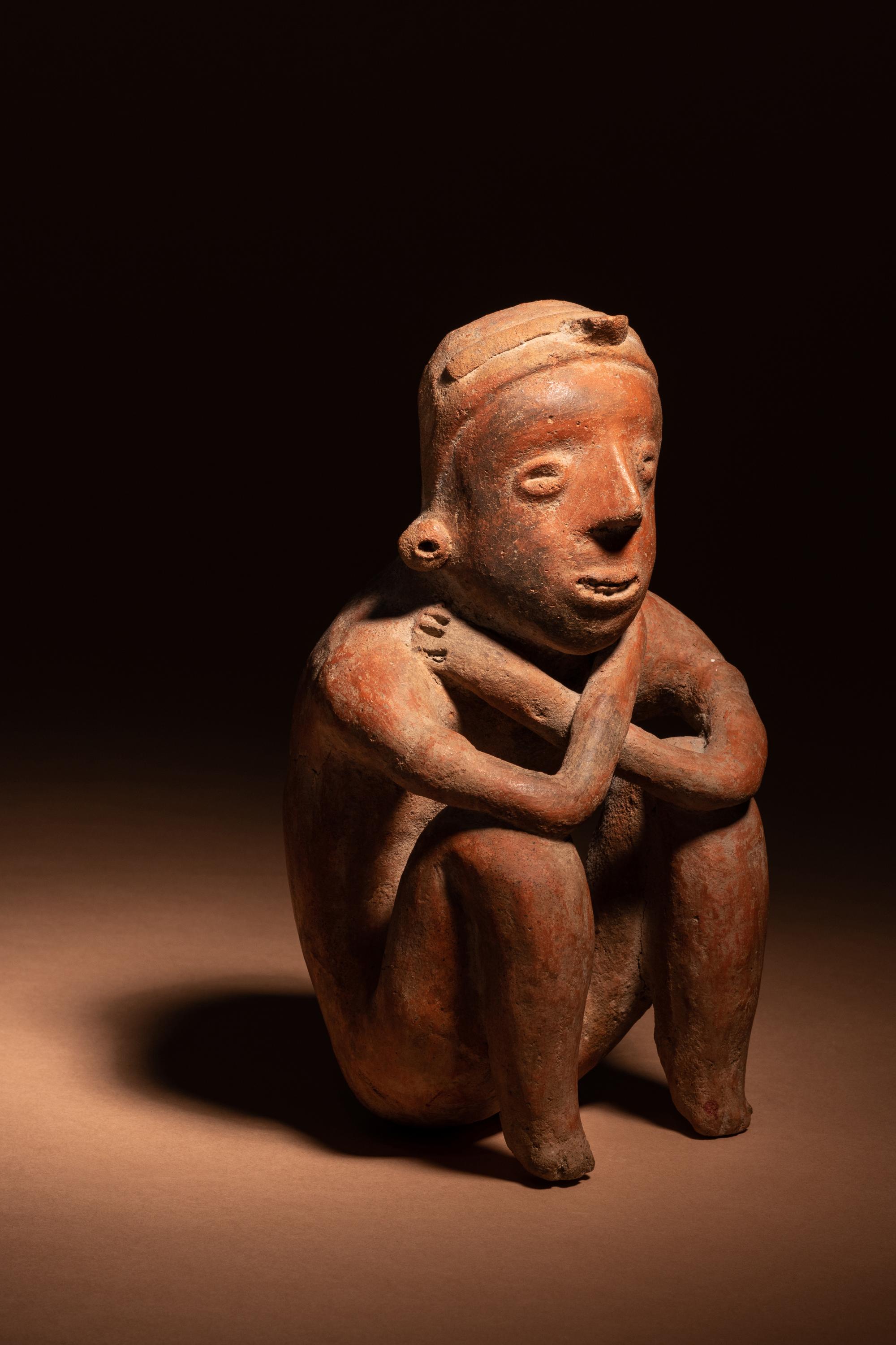 A Colima Terracotta Squatting Figure