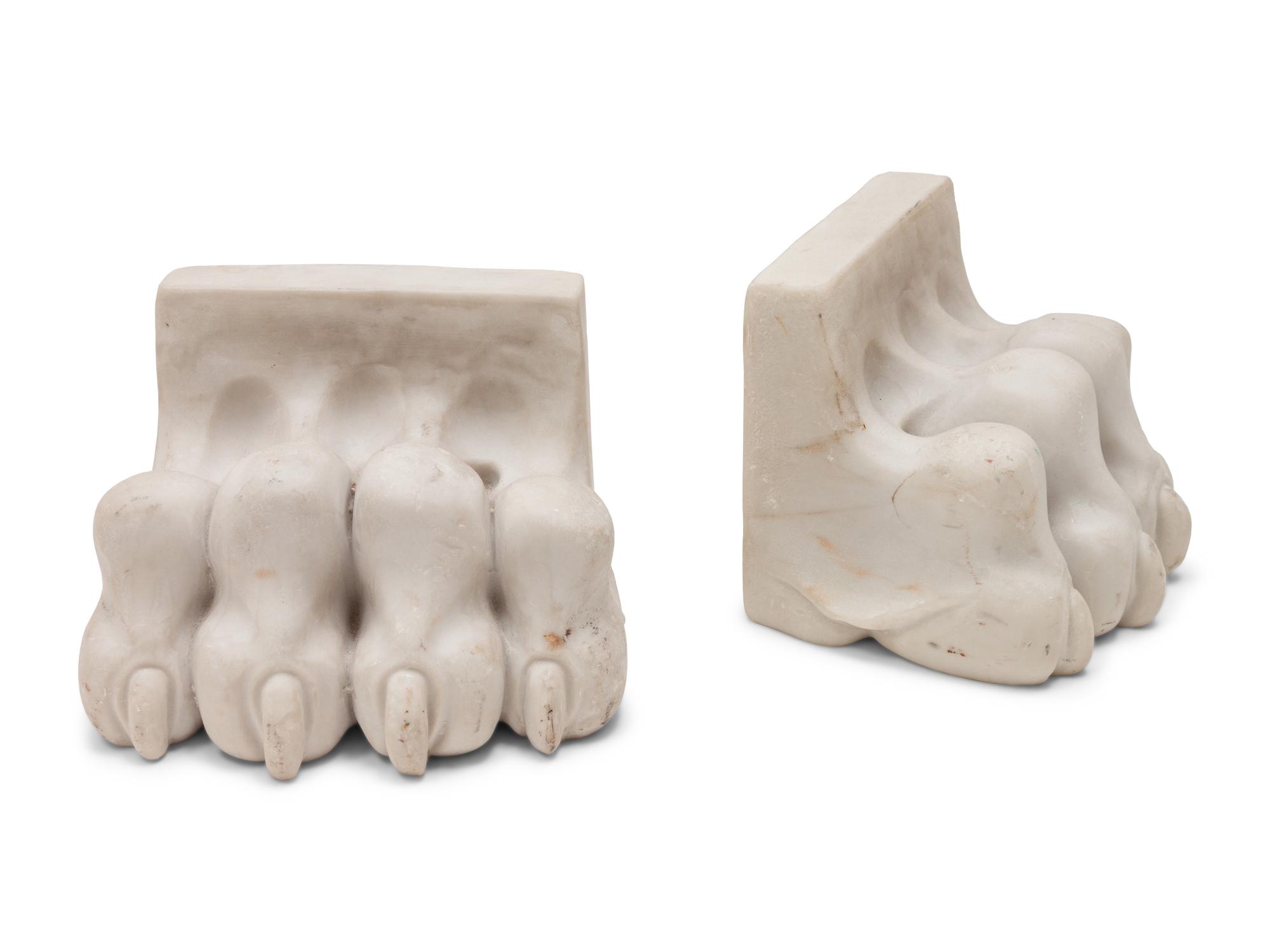 A Pair of Composition and Bronze Paw and Foot Form Doorstops