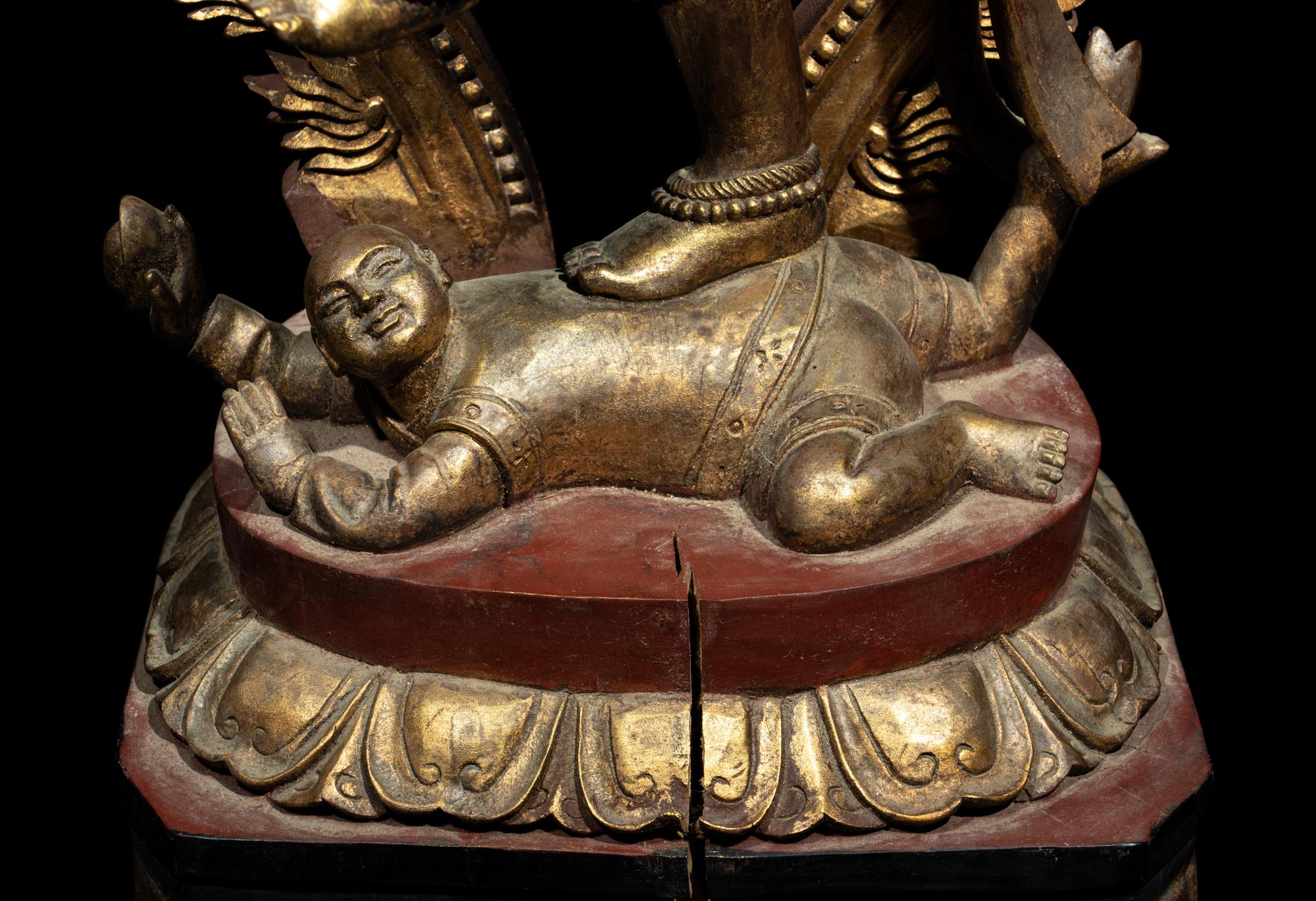 A Large Gilt and Red Lacquered Wood Figure of a Dancing Deity
