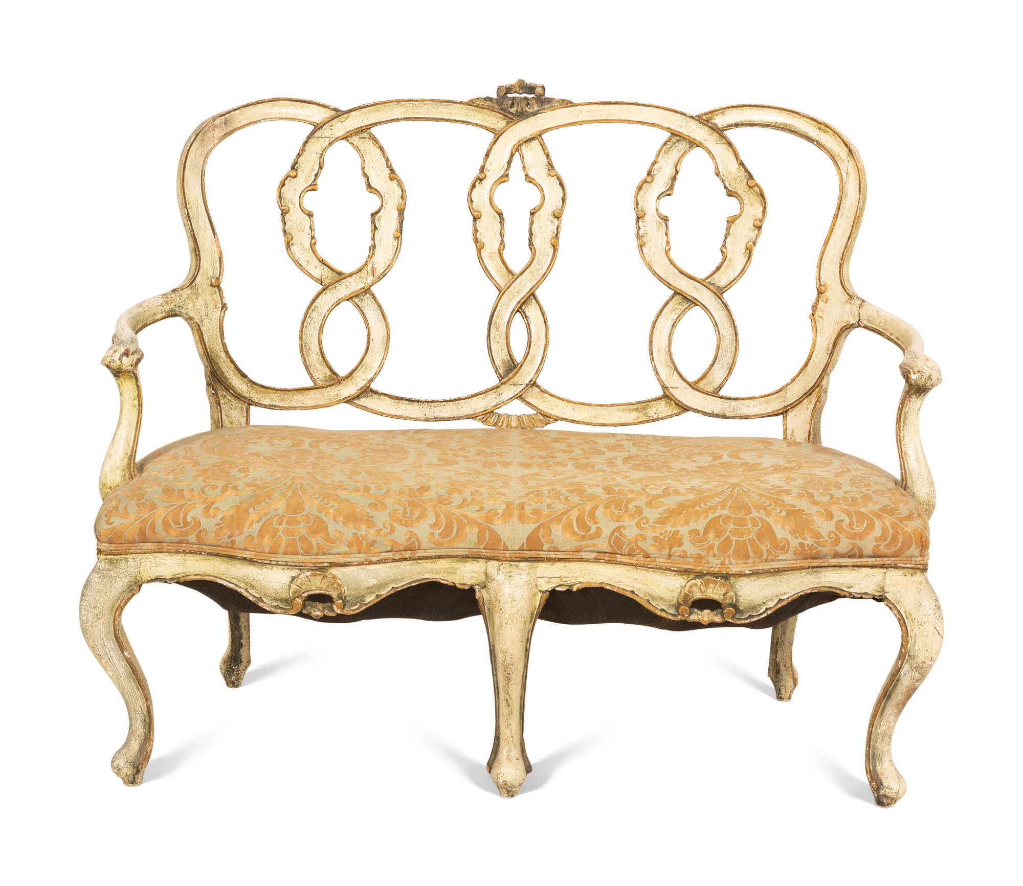 An Italian Painted and Parcel Gilt Settee with Fortuny Upholstery