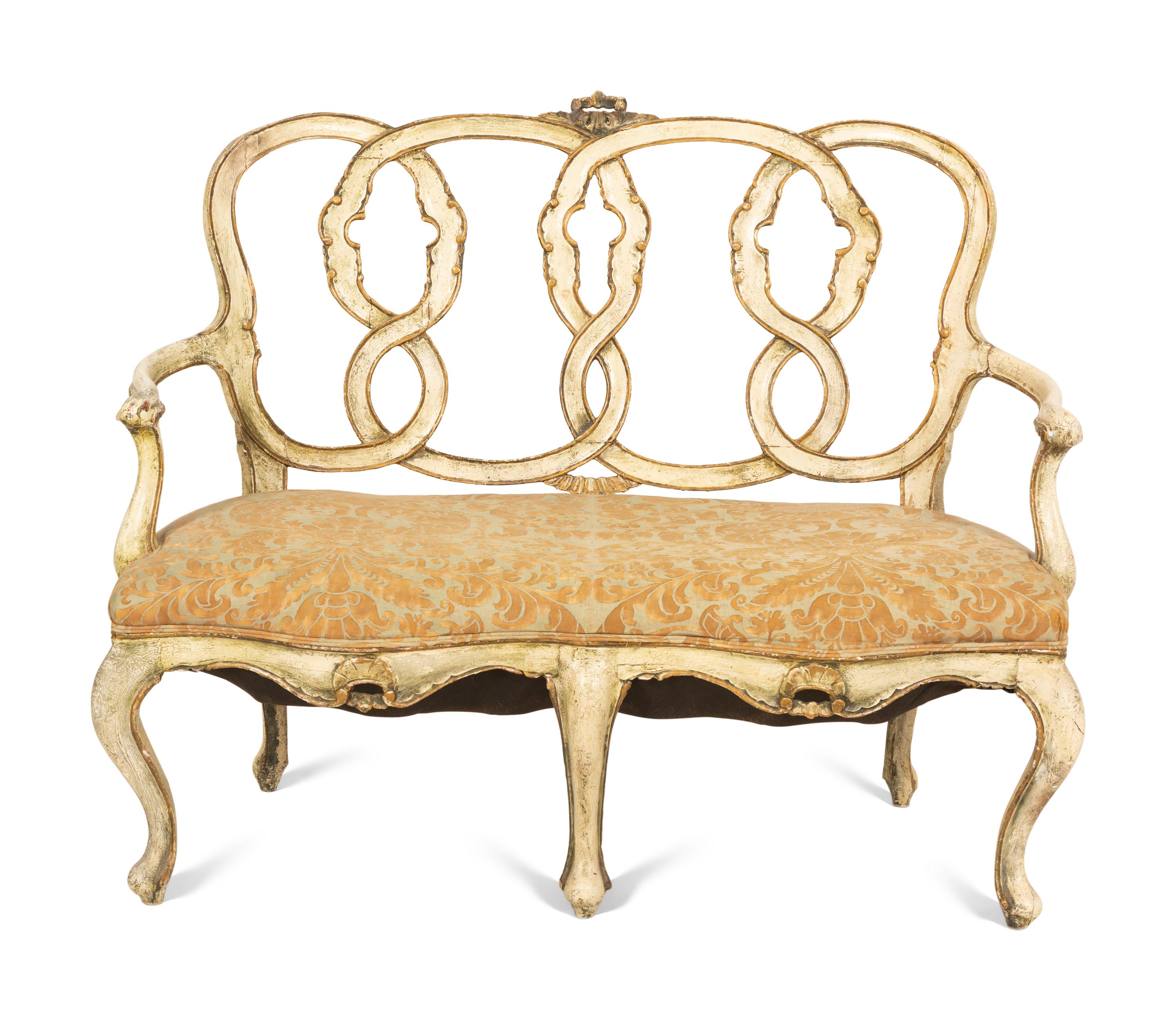An Italian Painted and Parcel Gilt Settee with Fortuny Upholstery