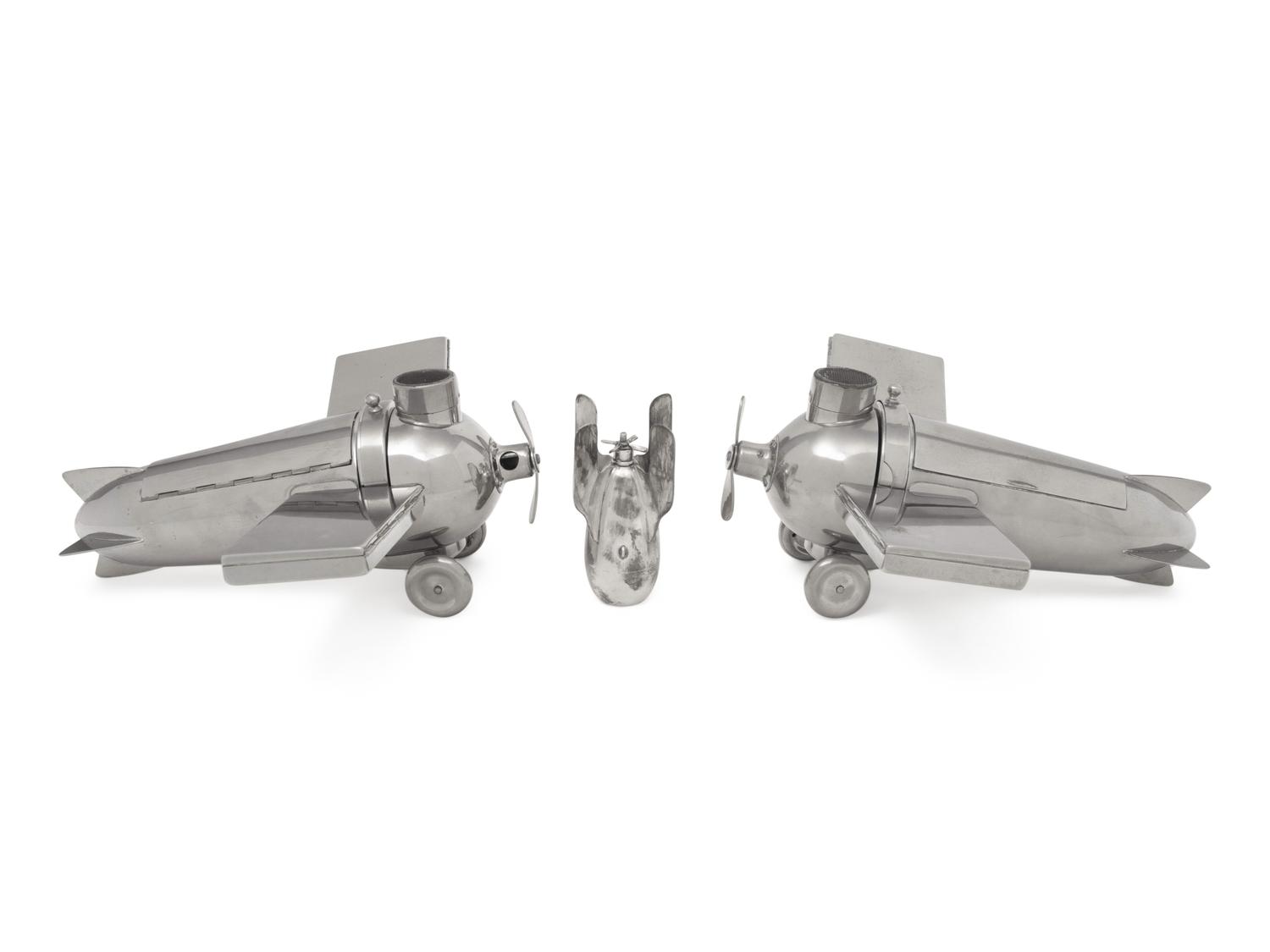 A Pair of German Chromed-Metal Airplane-Form Smoking Sets