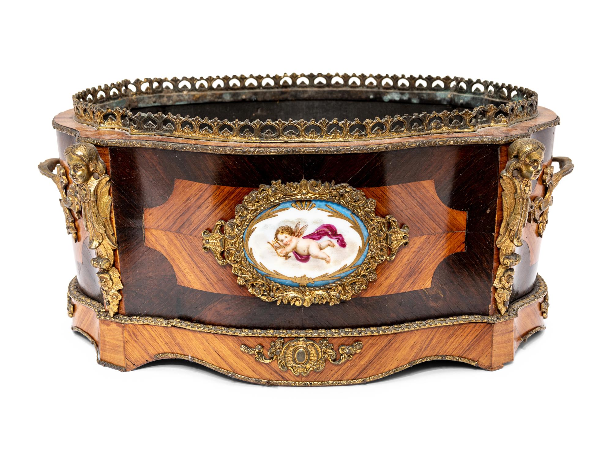 A French Porcelain and Gilt Bronze Mounted Kingwood Jardinière
