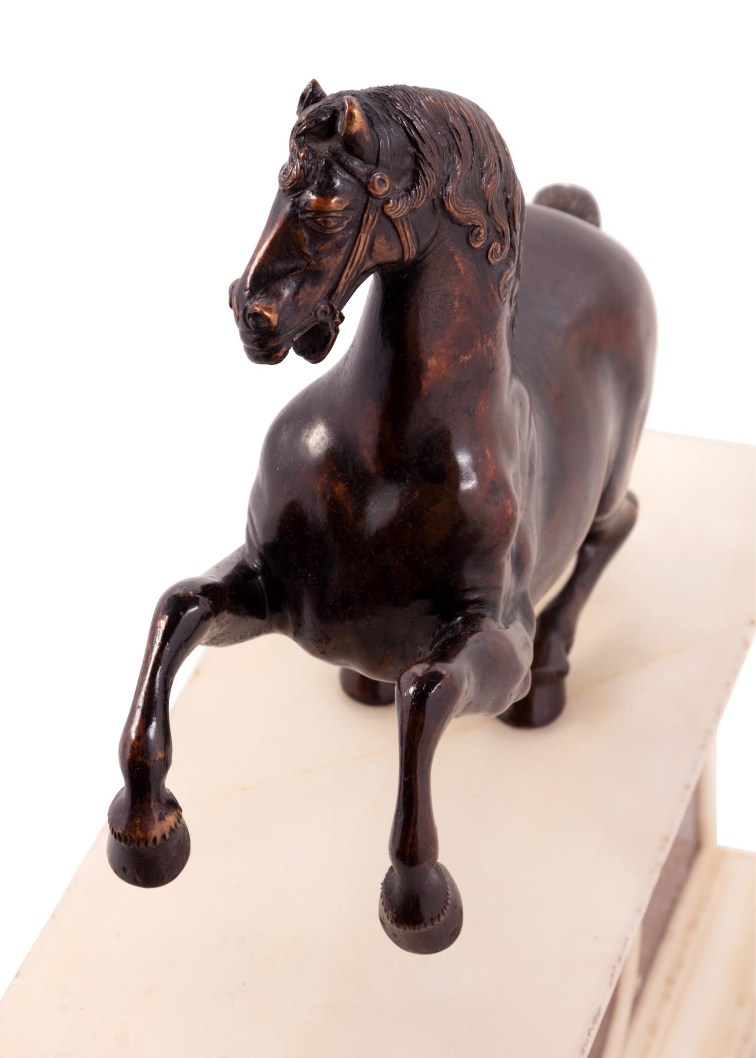 An Italian Bronze Model of a Horse on a White Marble and Porphyry Base