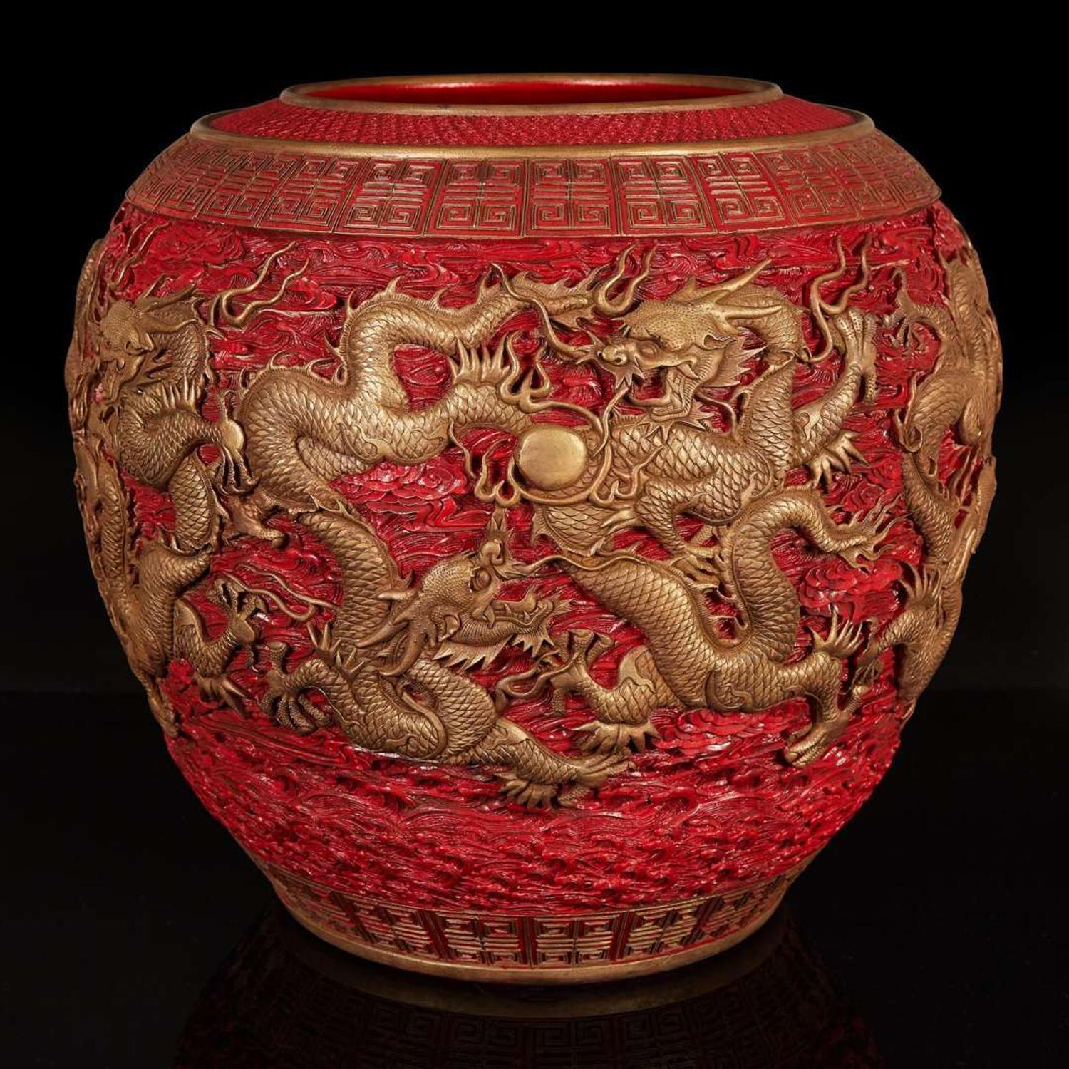 A massive Chinese faux cinnabar lacquer modeled porcelain "Dragons" jardinière 朱紅漆繪模印龍紋缸 Qianlong six character mark in relief to the neck ?????