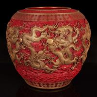 A massive Chinese faux cinnabar lacquer modeled porcelain "Dragons" jardinière 朱紅漆繪模印龍紋缸 Qianlong six character mark in relief to the neck ?????