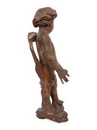 An Italian Carved Walnut Figure of Putto
