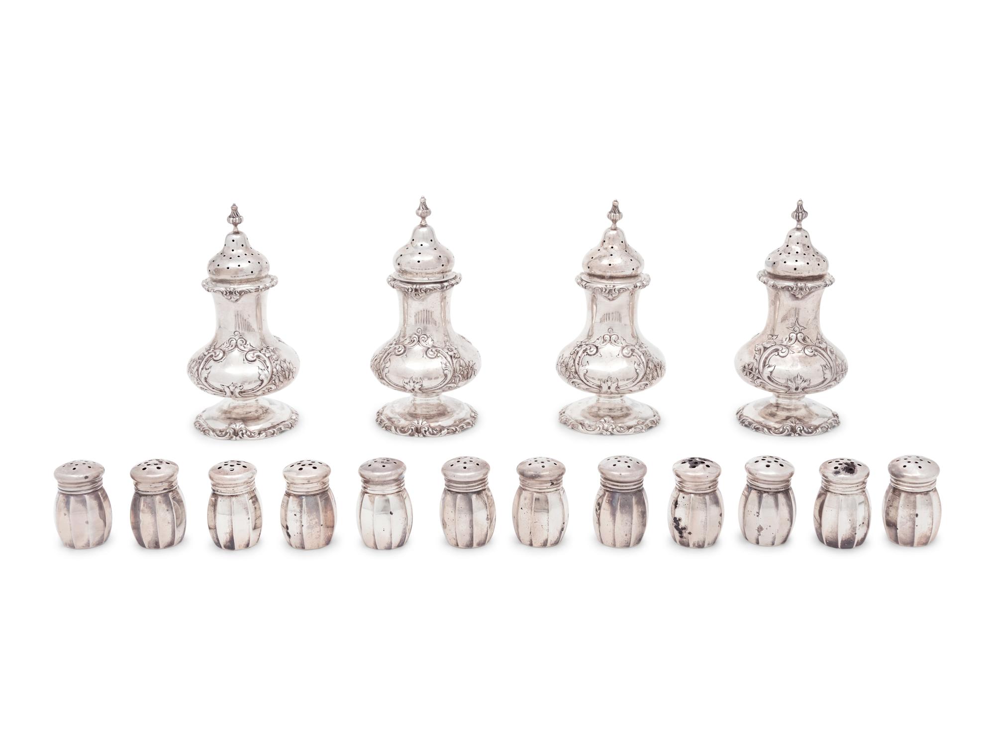 A Group of Sixteen Silver Casters