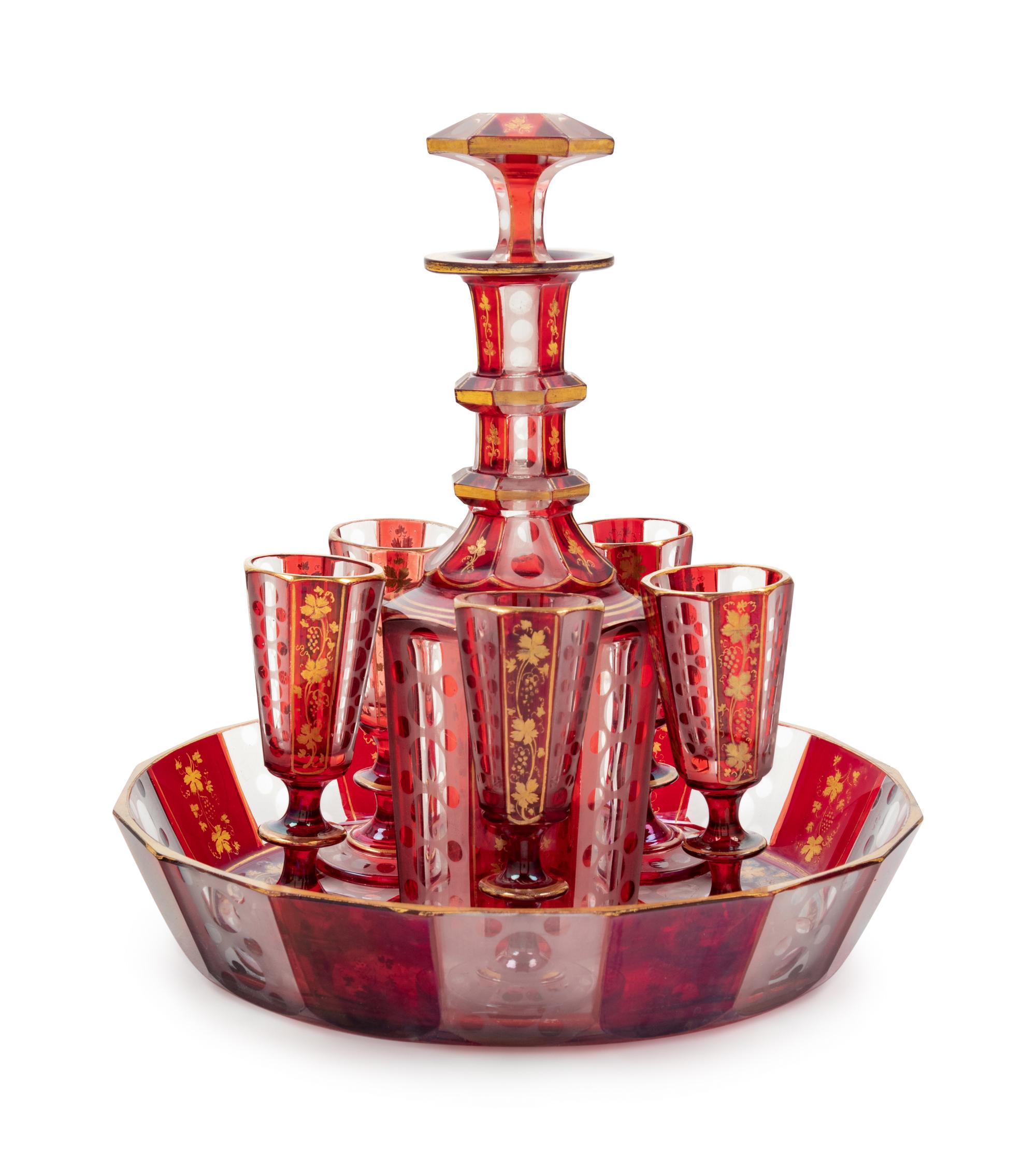 A Bohemian Gilt Decorated Ruby Cut-to-Clear Glass Liquor Set