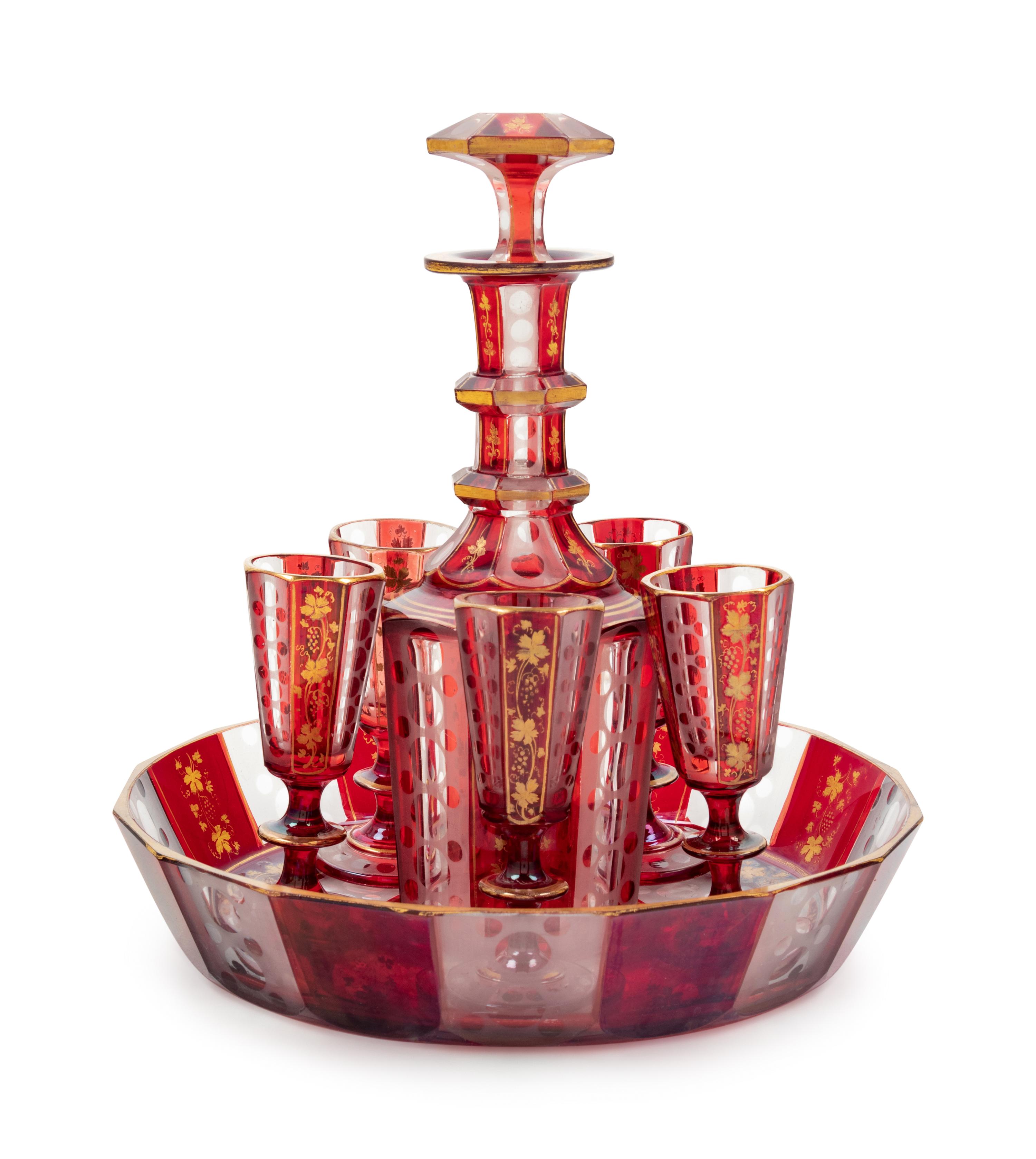 A Bohemian Gilt Decorated Ruby Cut-to-Clear Glass Liquor Set