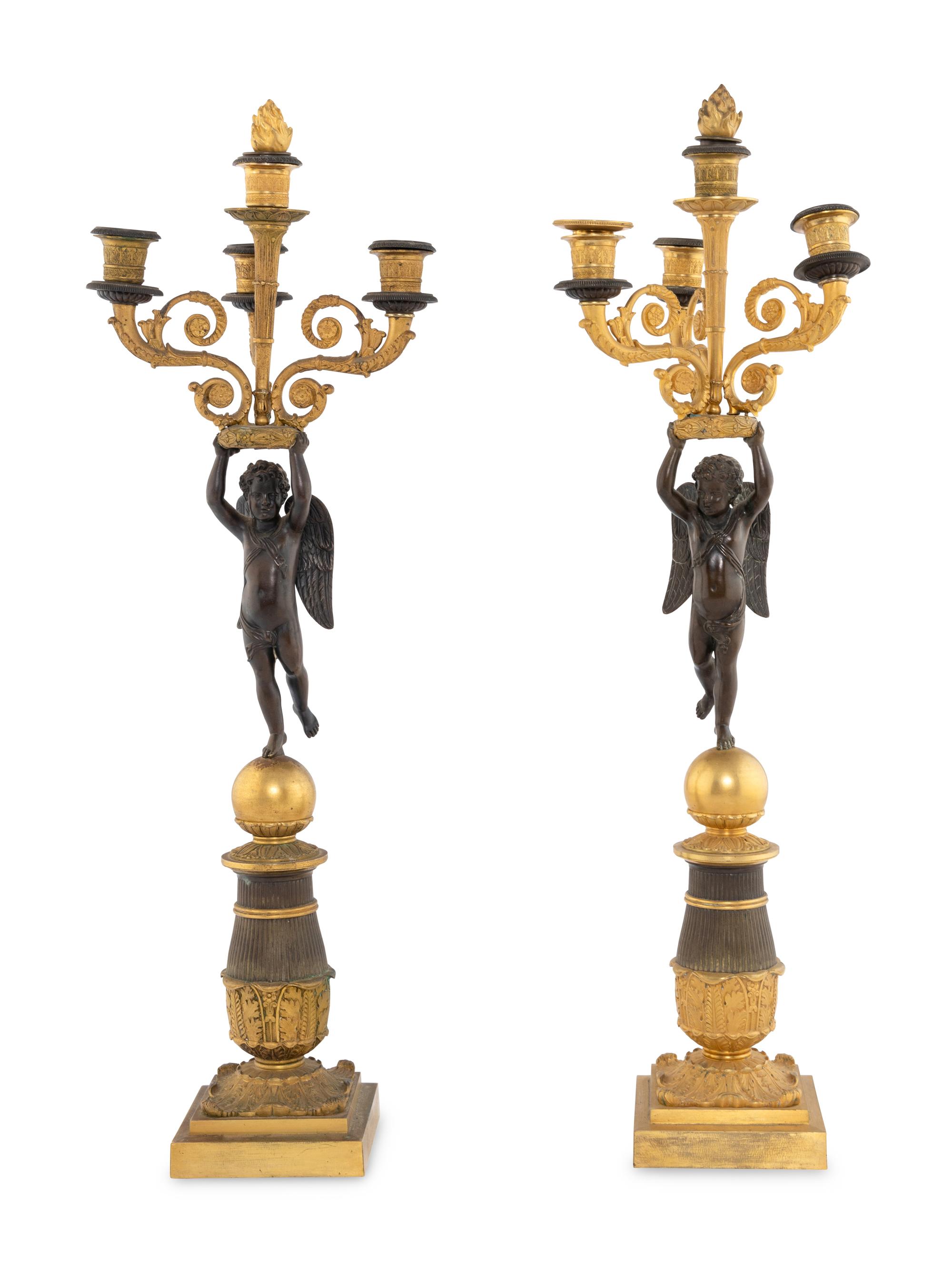 A Pair of Empire Style Gilt and Patinated Bronze Figural Candelabra