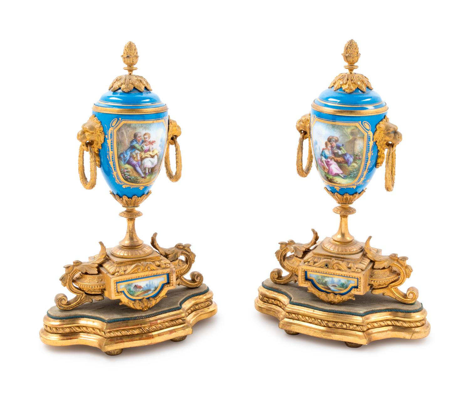 A Pair of Sèvres Style Gilt Bronze Mounted Painted and Parcel Gilt Porcelain Urns