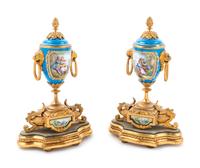 A Pair of Sèvres Style Gilt Bronze Mounted Painted and Parcel Gilt Porcelain Urns