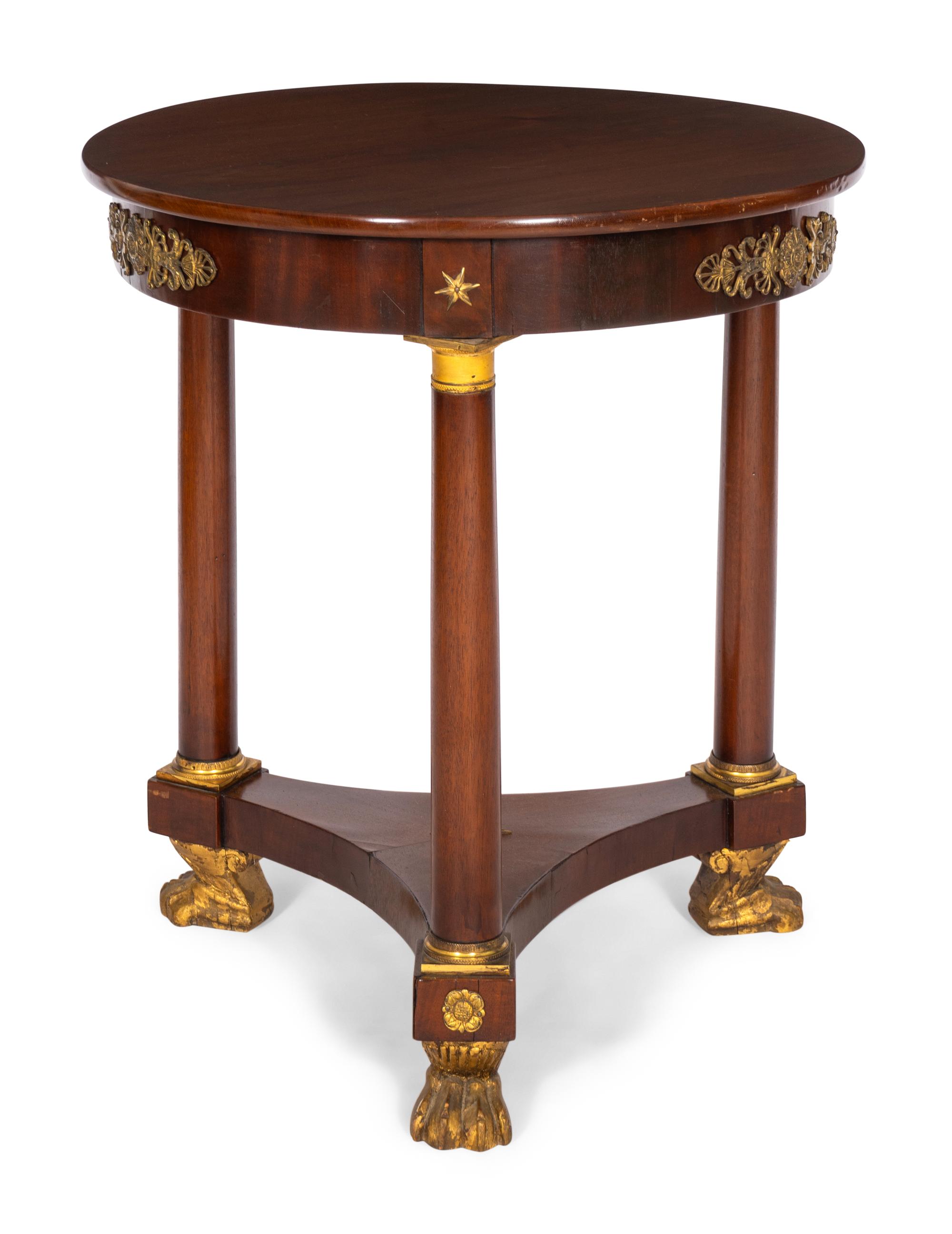 An Empire Style Gilt Bronze Mounted Parcel Gilt Mahogany Guéridon