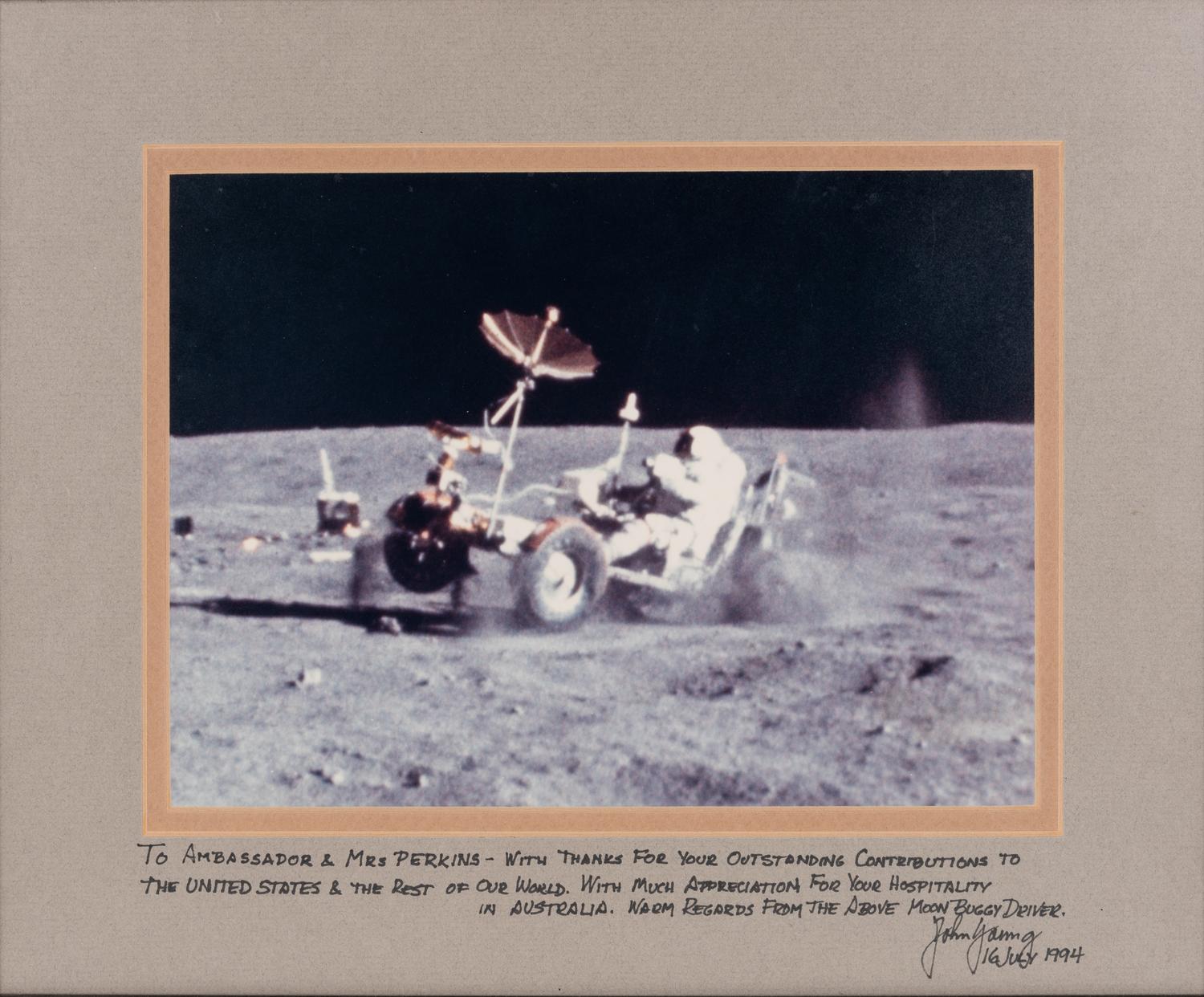YOUNG, John Watts (1930-2018). Photograph of Young driving a moon buggy, signed (“John Young”) to Ambassador Edward Joseph Perkins.