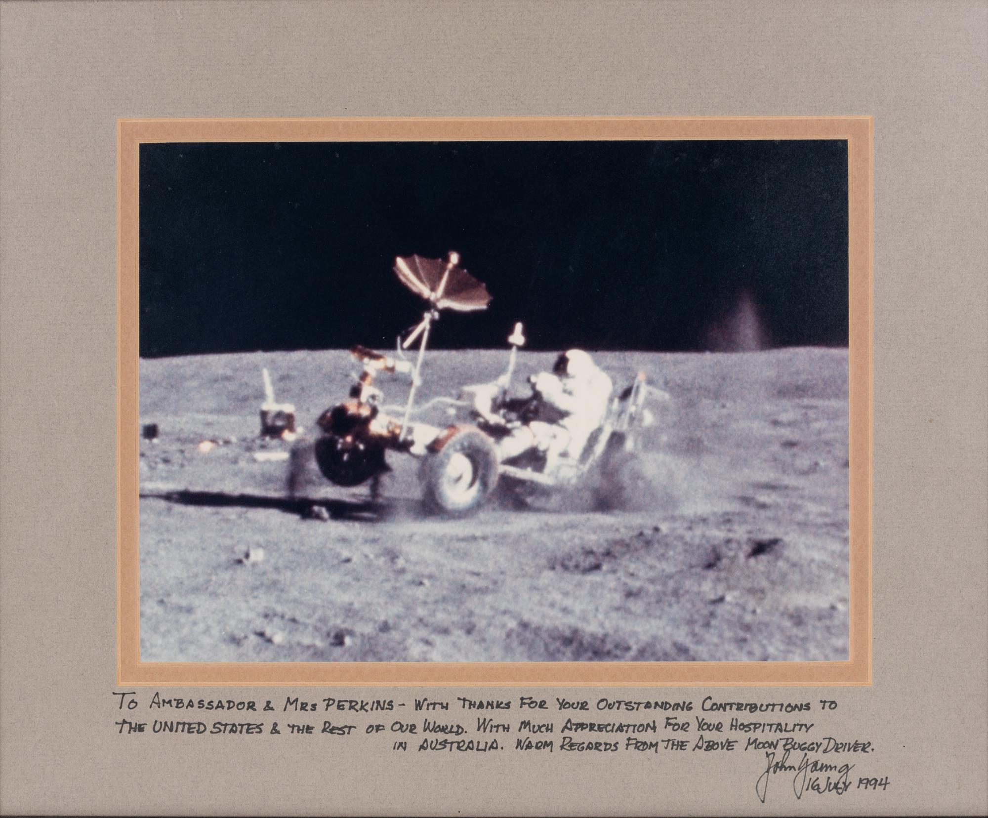 YOUNG, John Watts (1930-2018). Photograph of Young driving a moon buggy, signed (“John Young”) to Ambassador Edward Joseph Perkins.