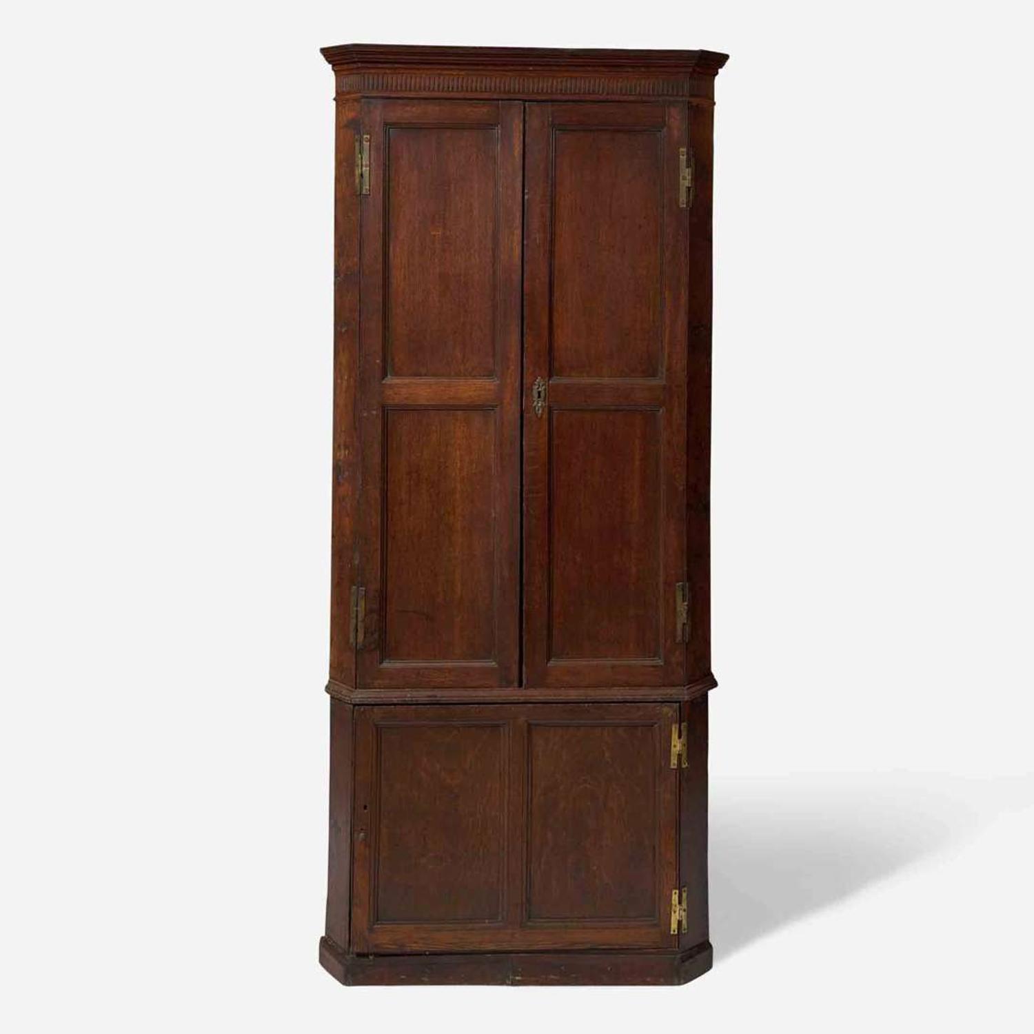 A George III carved oak corner cupboard late 18th century