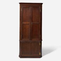 A George III carved oak corner cupboard late 18th century