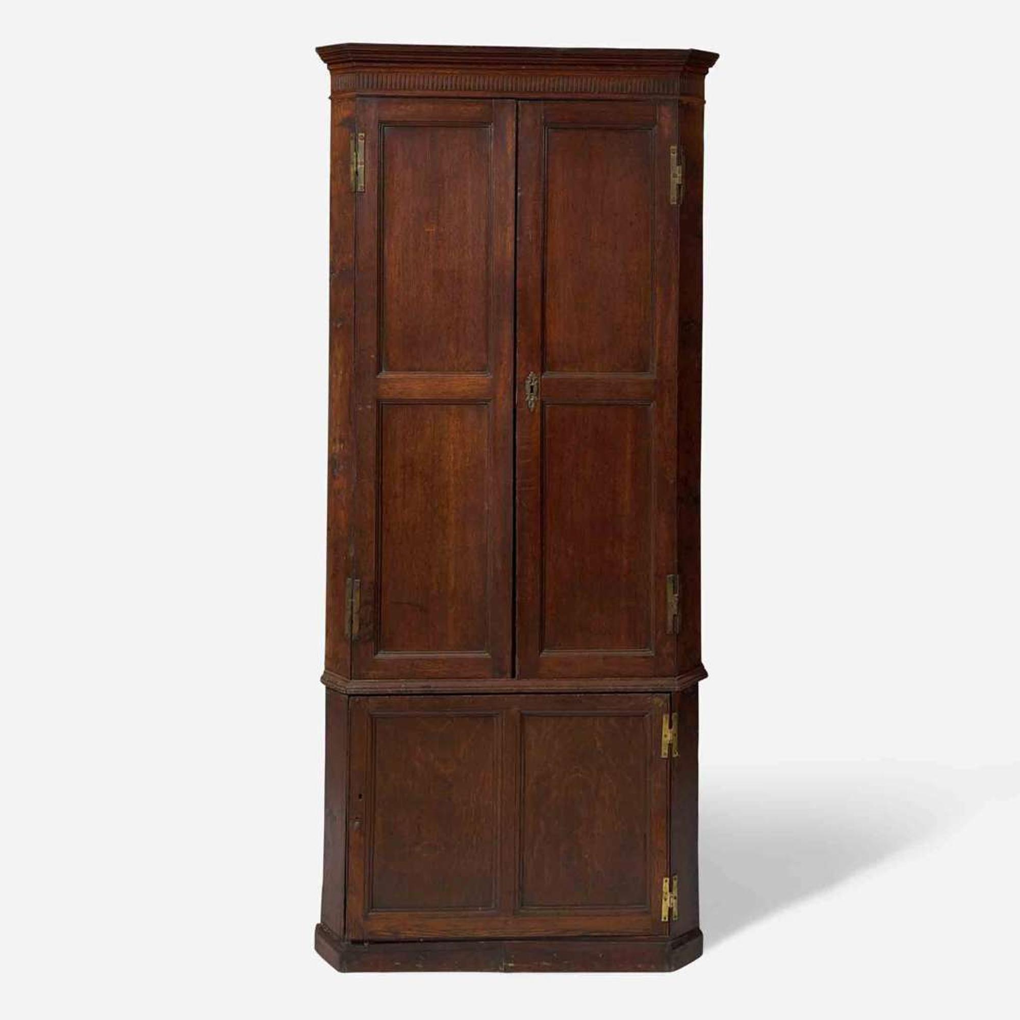A George III carved oak corner cupboard late 18th century