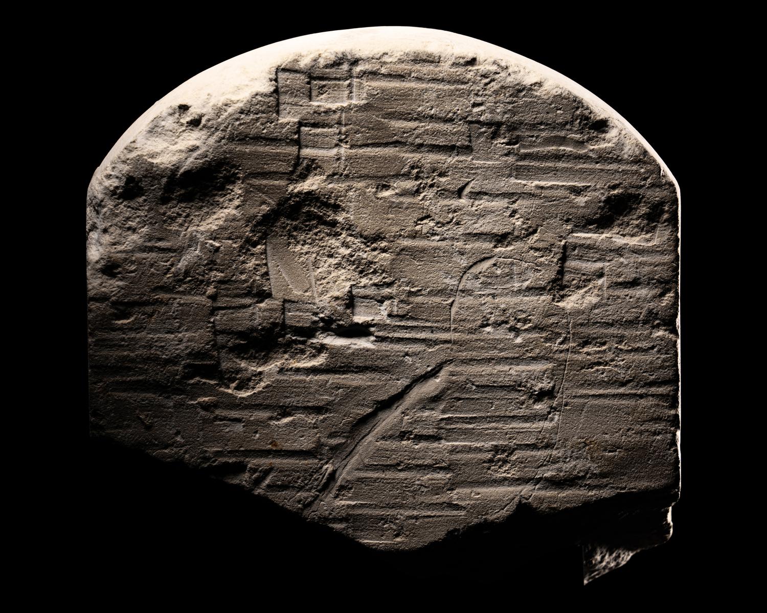 An Egyptian Limestone Round-Topped Stele