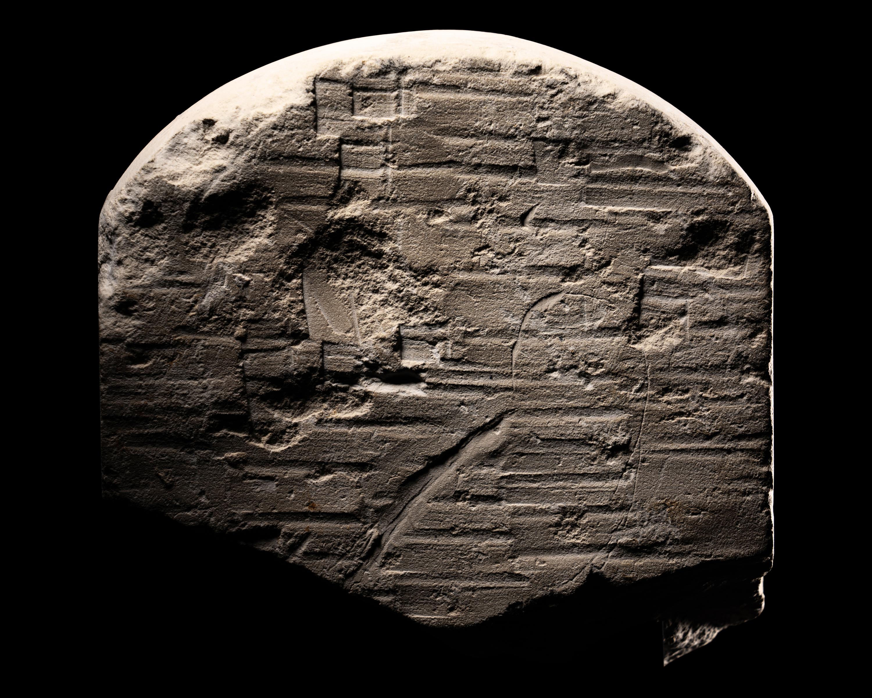 An Egyptian Limestone Round-Topped Stele