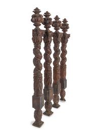 A Set of Four Continental Baroque Carved Walnut Bed Posts