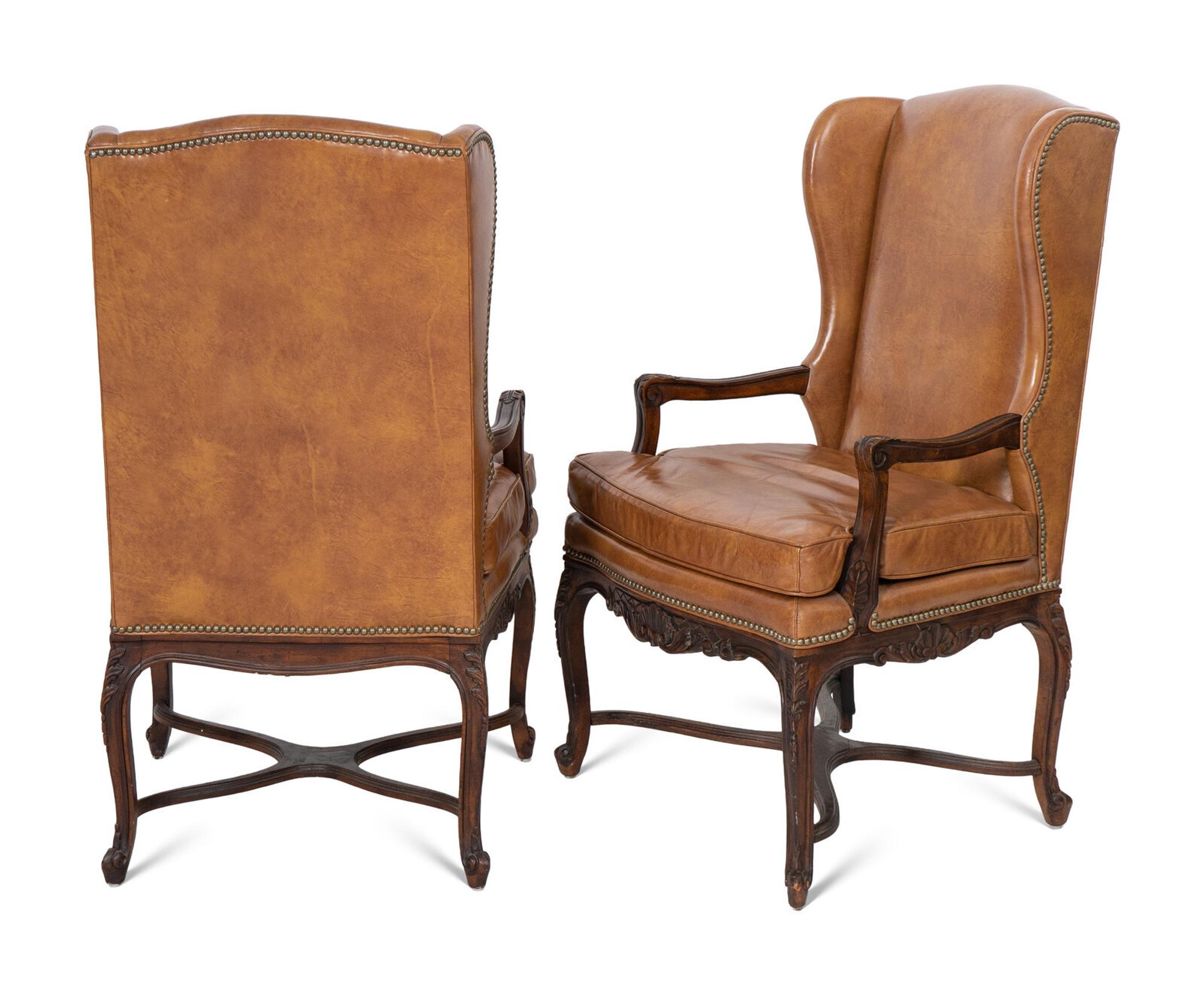 A Pair of Régence Style Leather-Upholstered Wingback Chairs
