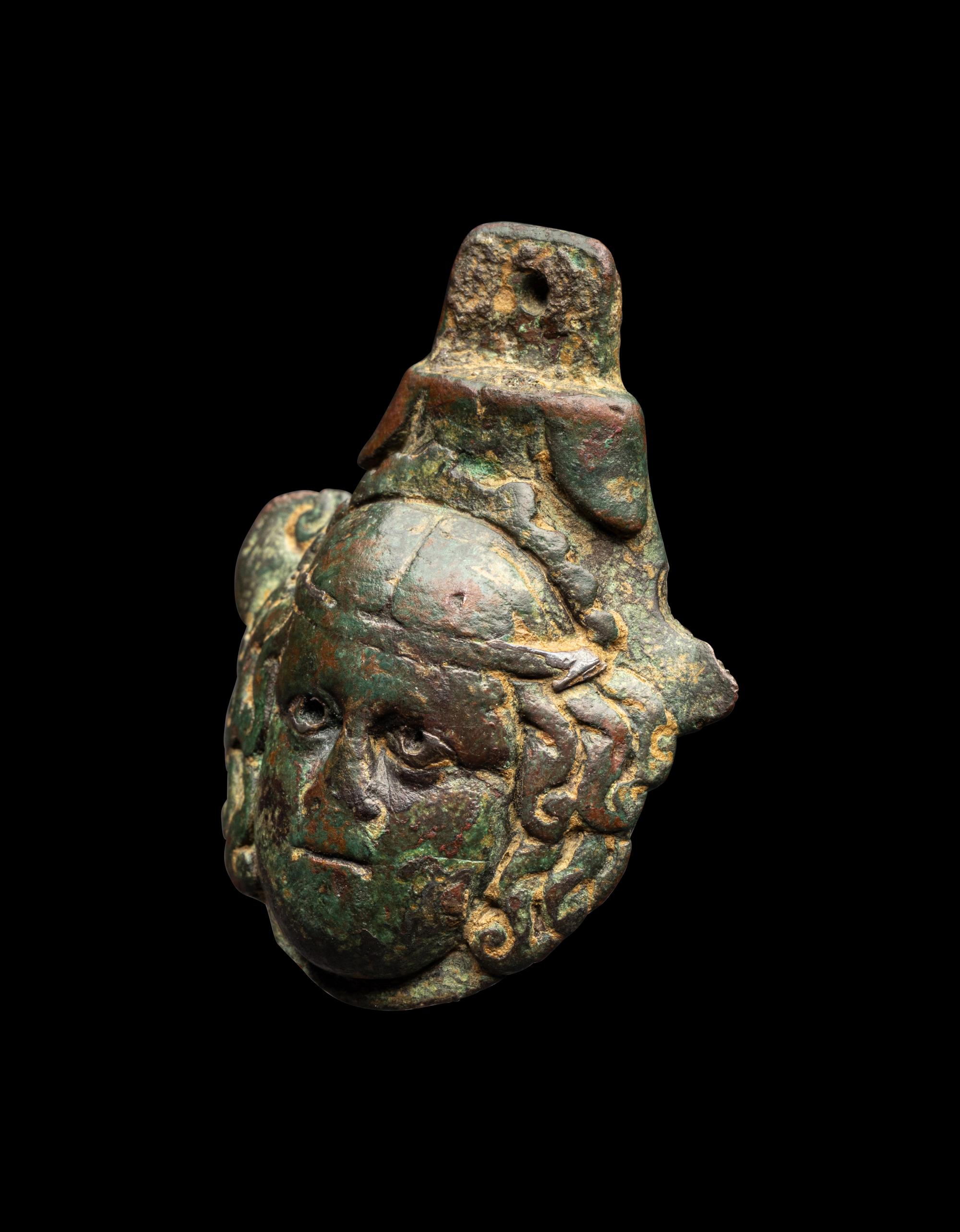 A Roman Bronze Terminal in the Form of a Medusa Head with Silver Inlaid Eyes