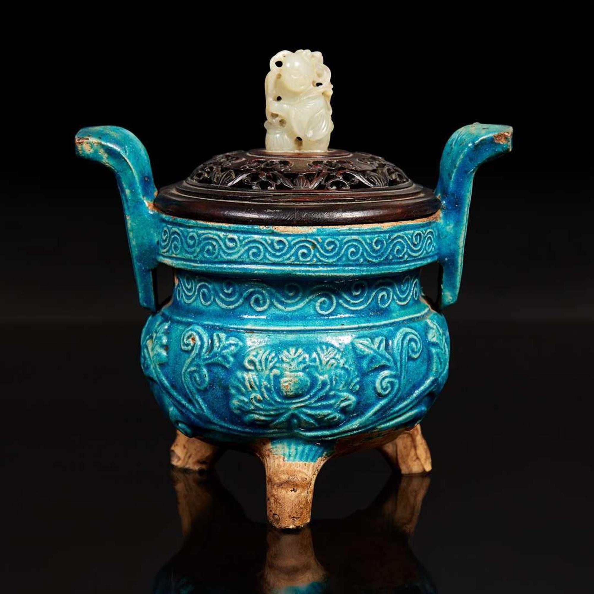 A Chinese turquoise-glazed tripod censer with carved wood cover and jade finial 松石綠地嵌玉鈕帶蓋小香爐
