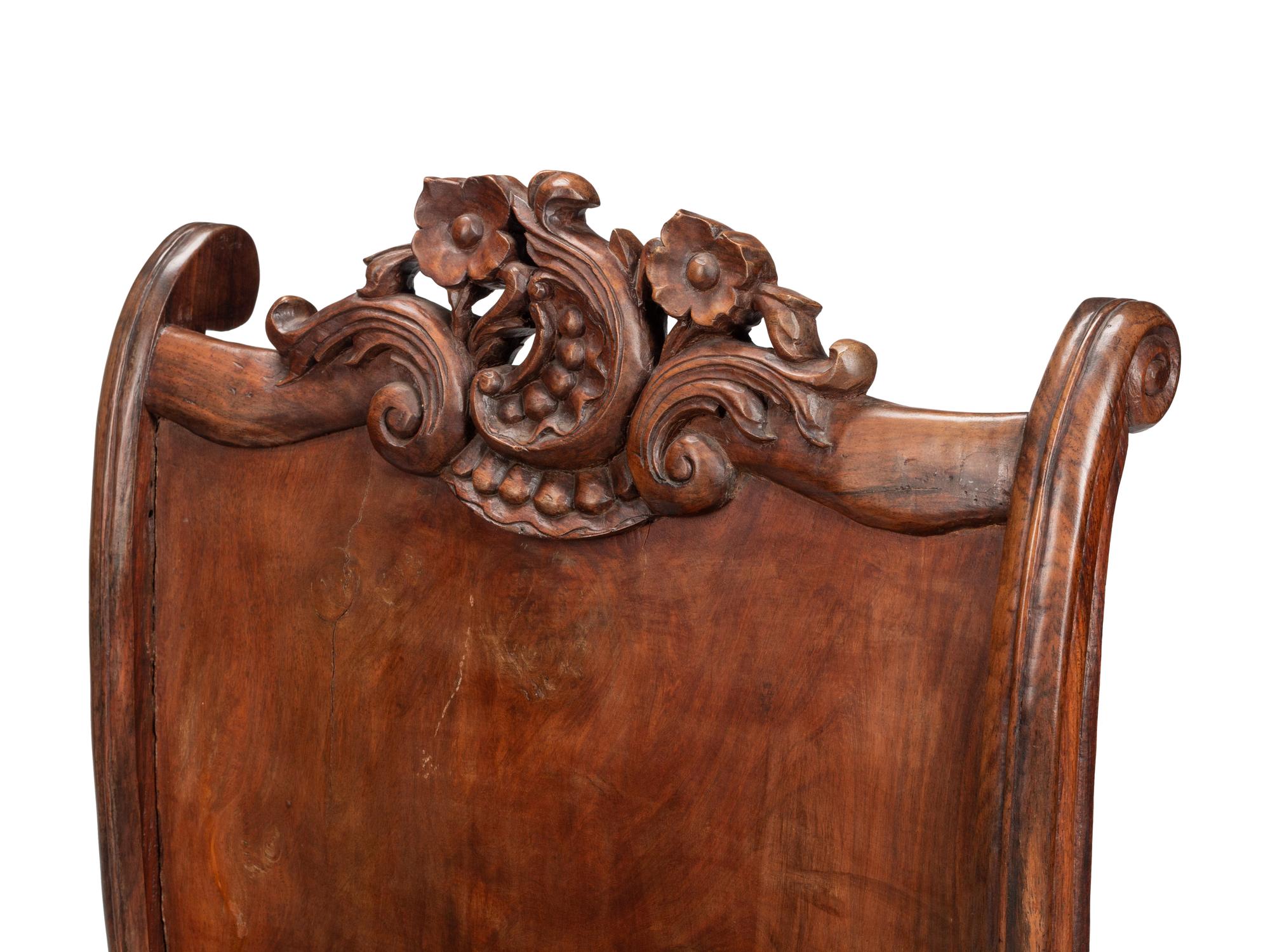 A Pair of Portuguese Colonial Carved Walnut Reclining Armchairs